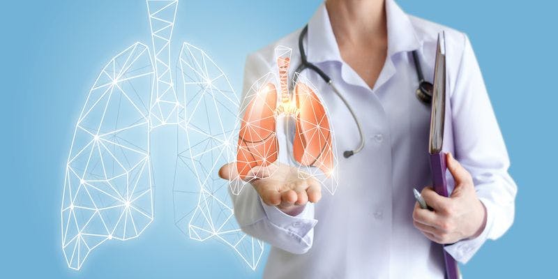 doctor holding CGI lungs diagram in her hand