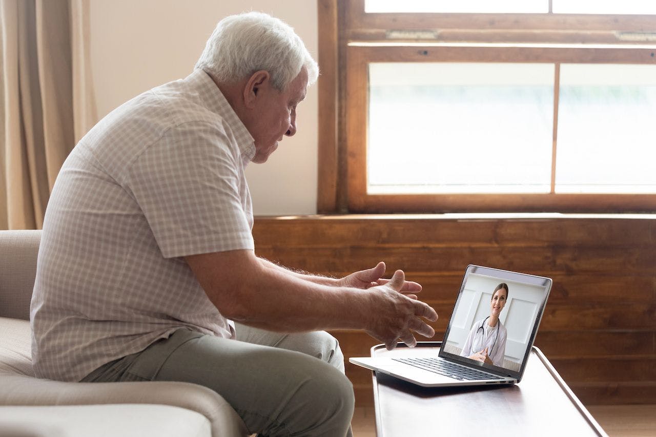 Senior man video chats with doctor online in telehealth visit: © fizkes - stock.adobe.com