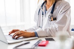 a health provider types on a computer