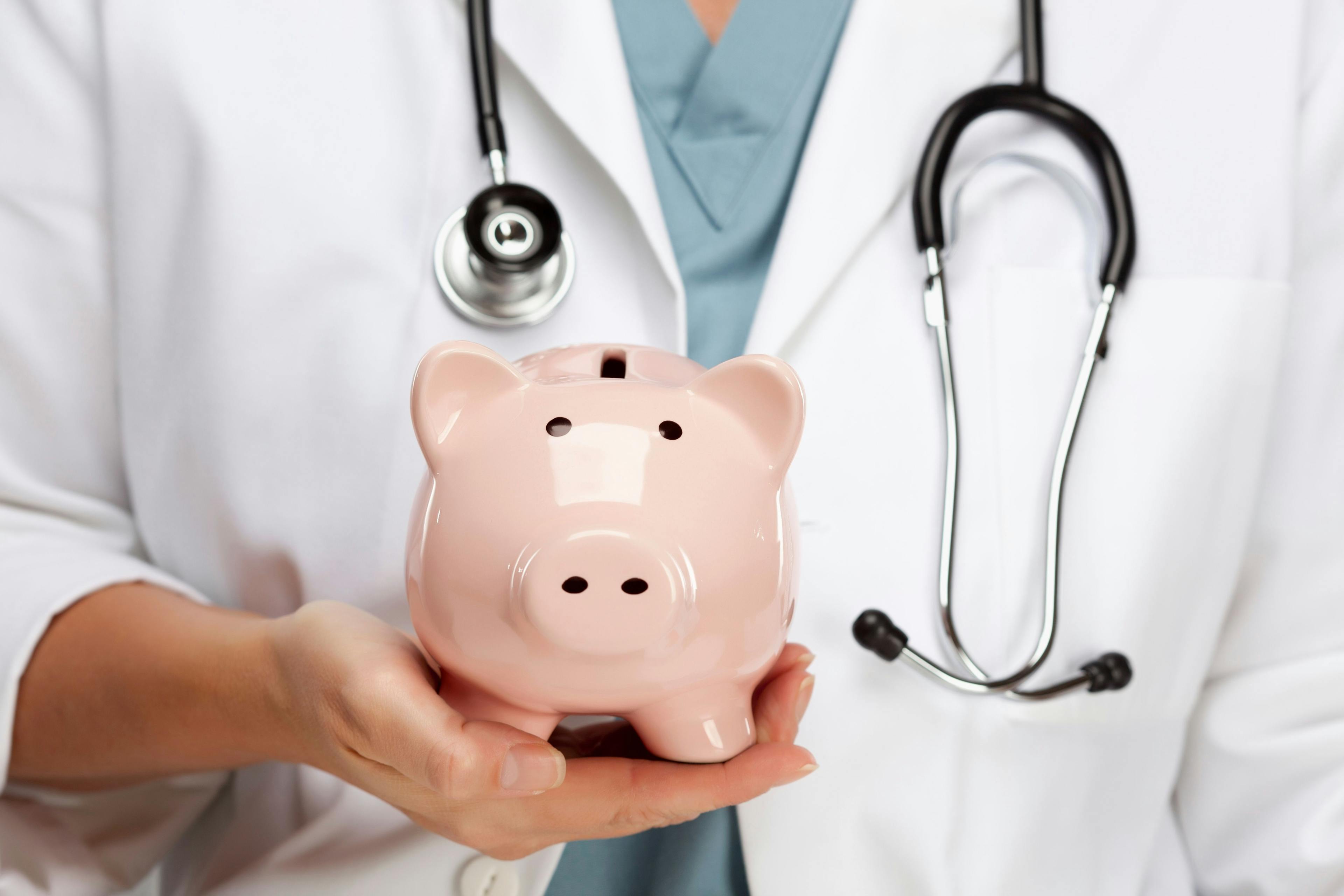 Doctor Holding Piggy Bank | image credit: Andy Dean - stock.adobe.com