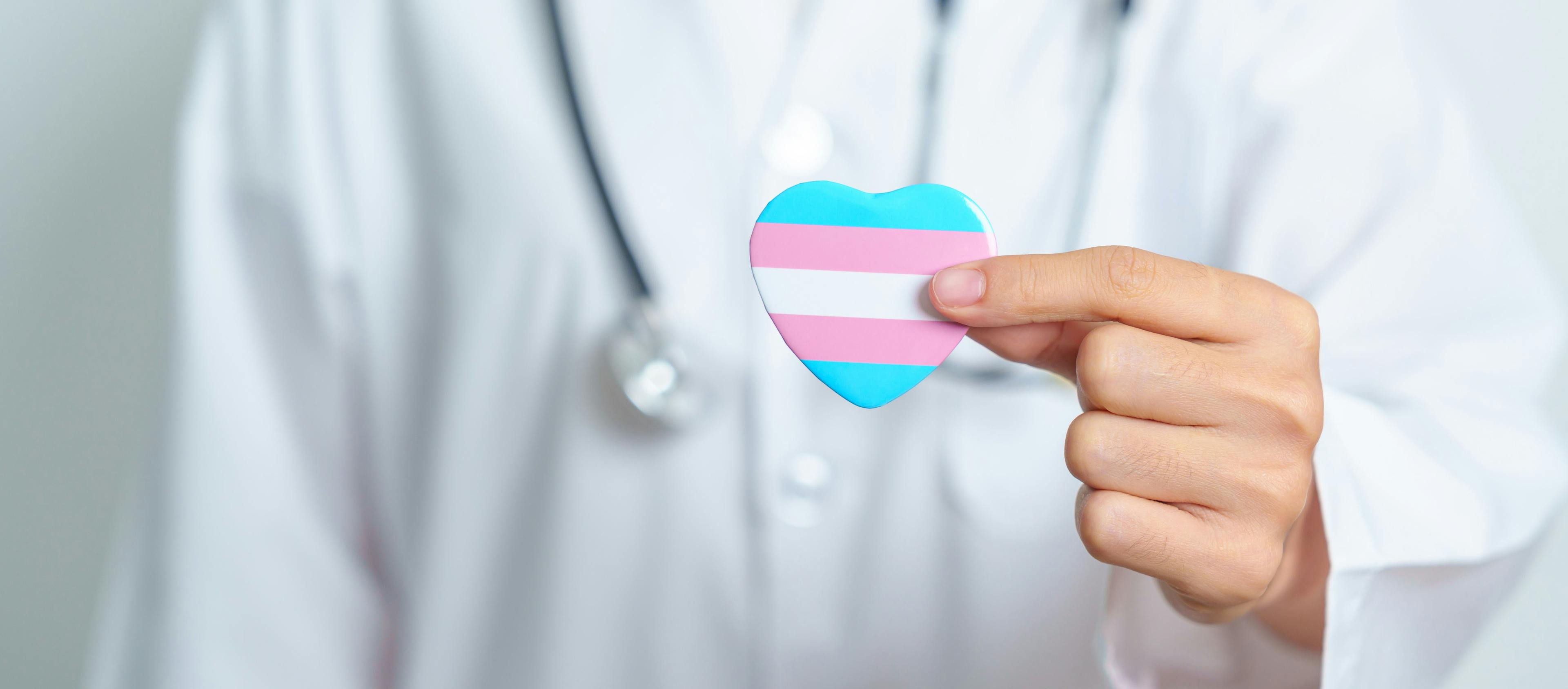 Clinician Holding Transgender Pride Pin | image credit: Jo Panuwat D - stock.adobe.com