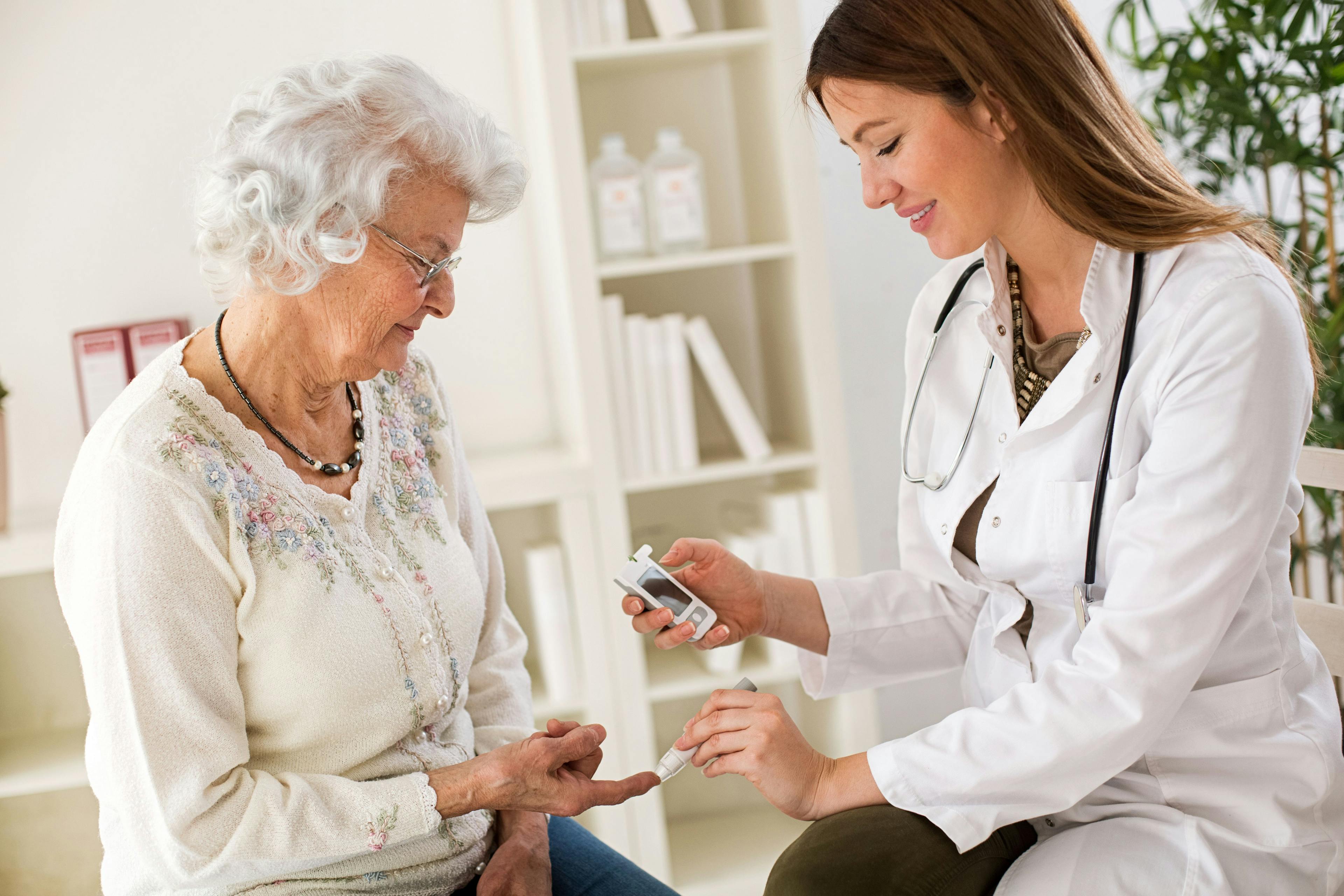 Older woman receiving blood sugar test