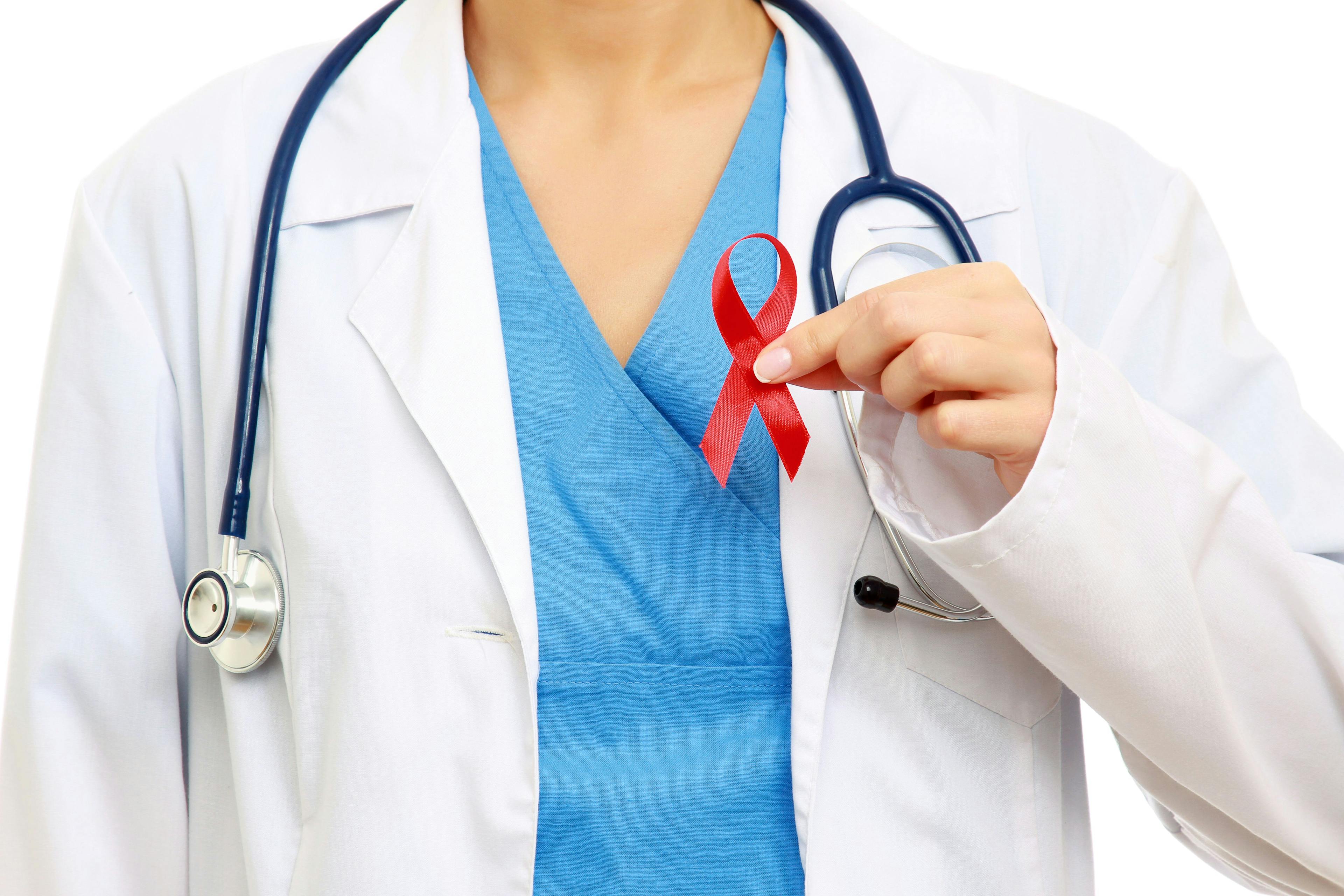 doctor holding up red HIV ribbon