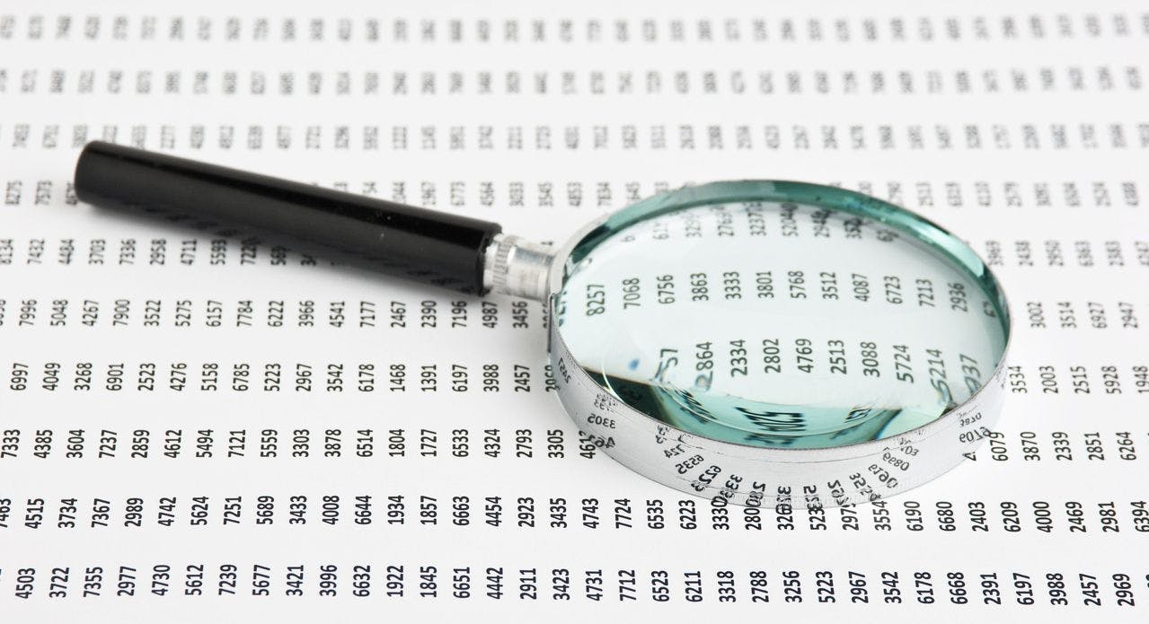 magnifying glass over a data sheet