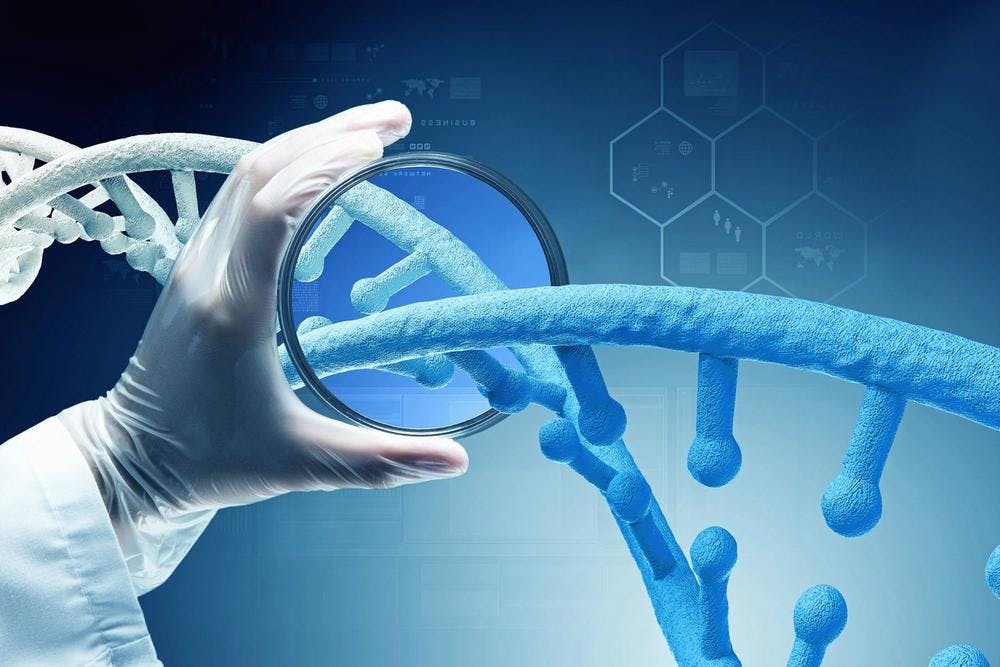 hand holding magnifying glass over DNA strand