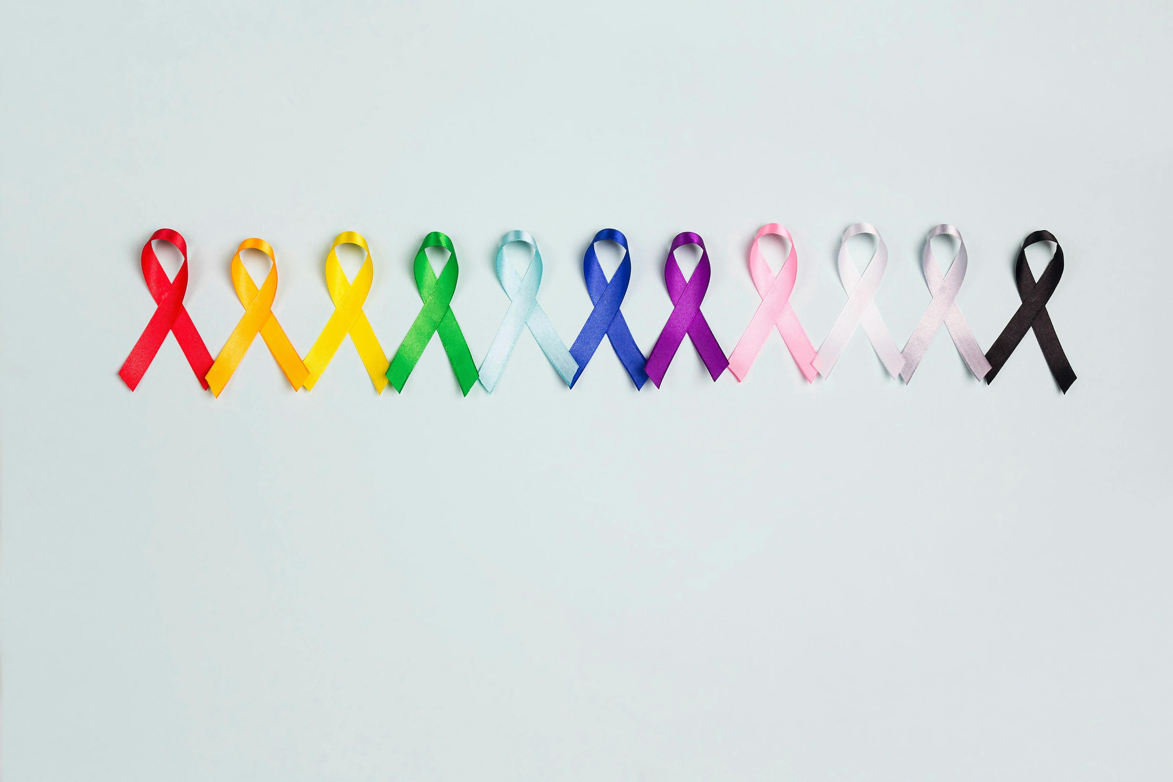 World cancer day concept, February 4. Colorful awareness ribbons on blue background. | Image Credit: WindyNight – stock.adobe.com
