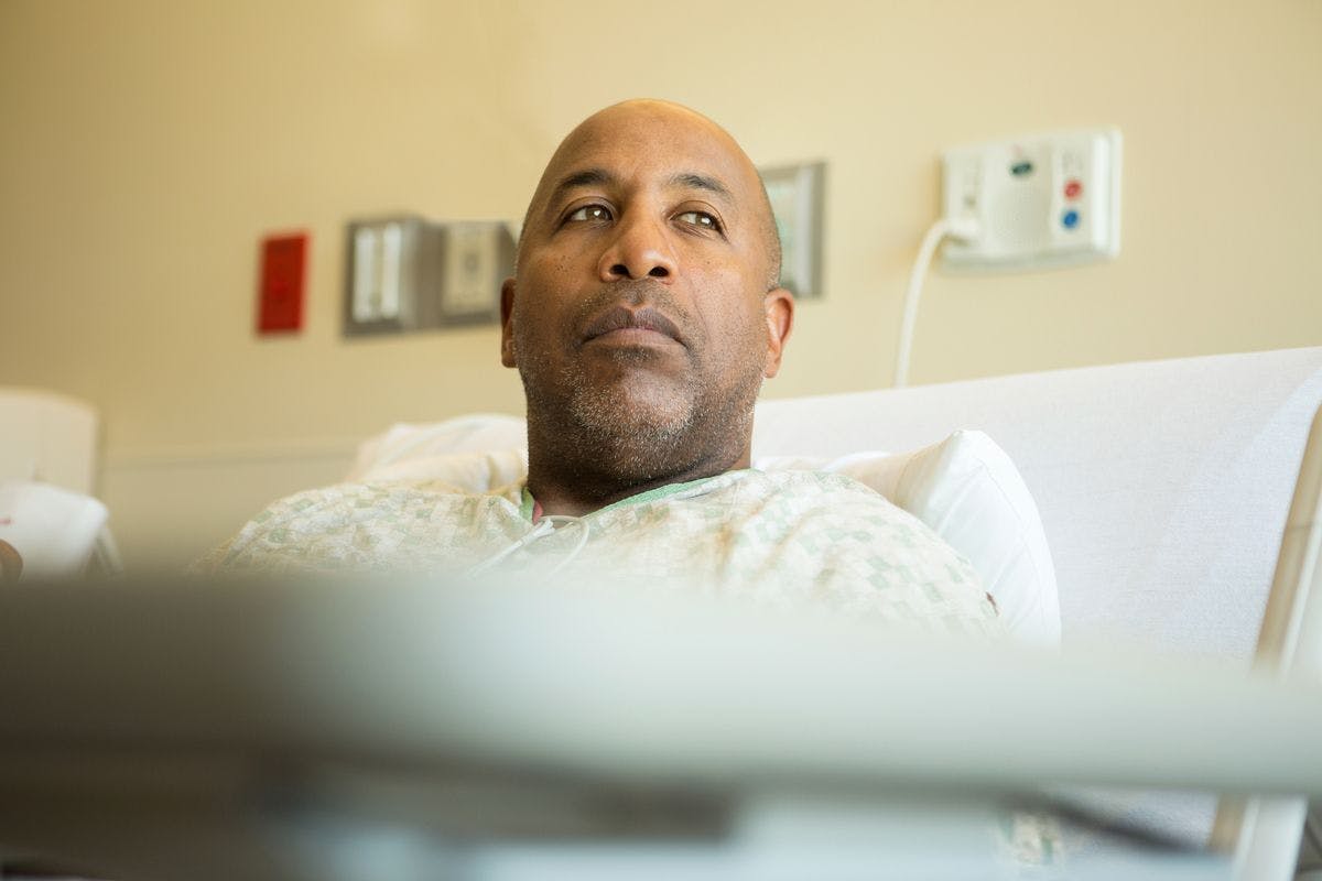 Black male patient in hospital bed