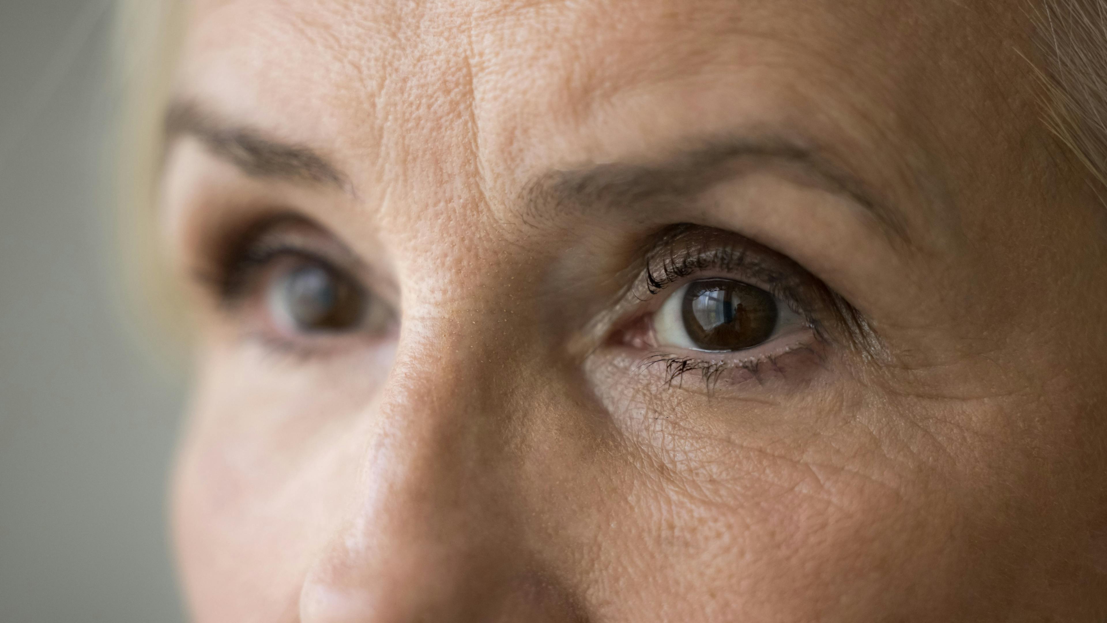 Brown eyes of older senior woman with black mascara on eyelashes looking away | Image credit: fizkes - stock.adobe.com