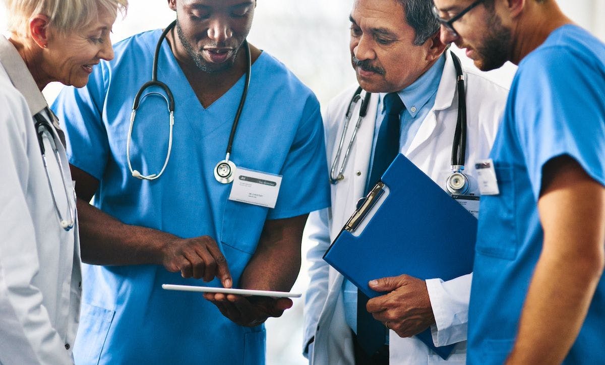 Doctors discussing a case | Image Credit: DelmaineDonson - stock.adobe.com