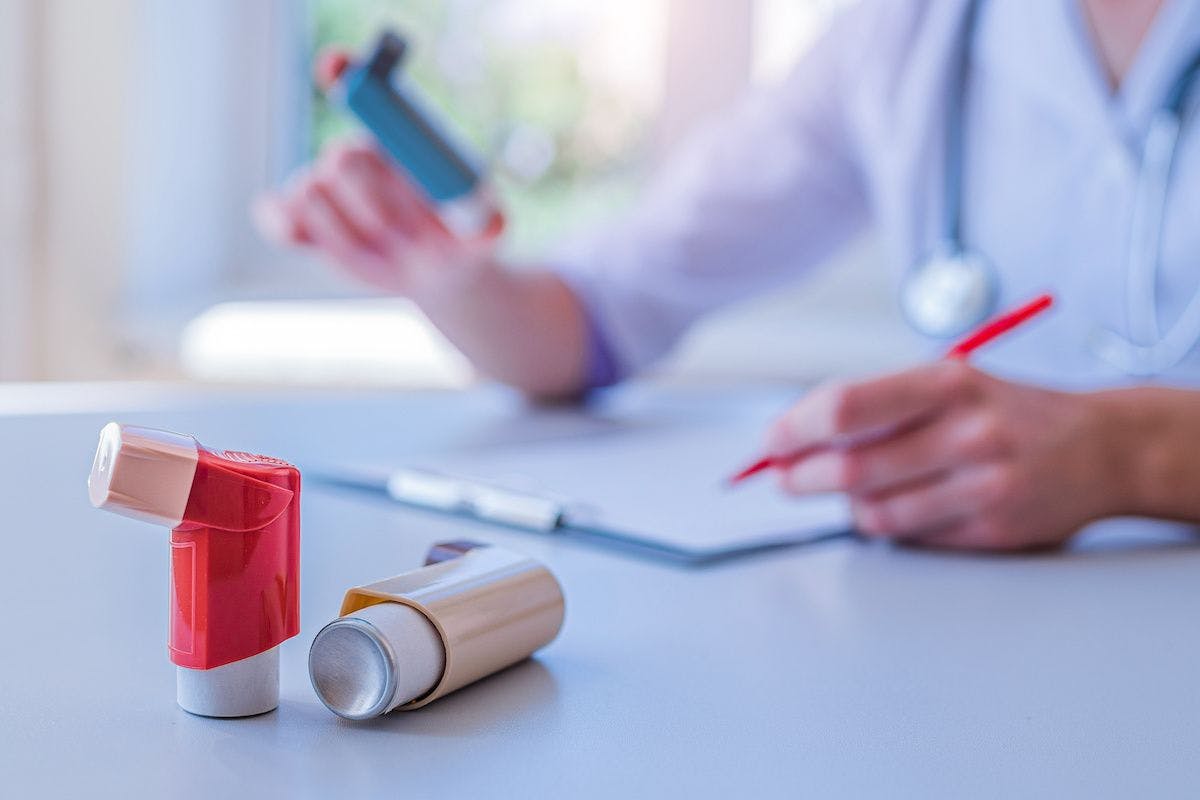 Doctor writes medical prescription for asthma inhaler to asthmatic patient during medical consultation and examination in hospital. Healthcare | Image Credit: © Goffkein - stock.adobe.com