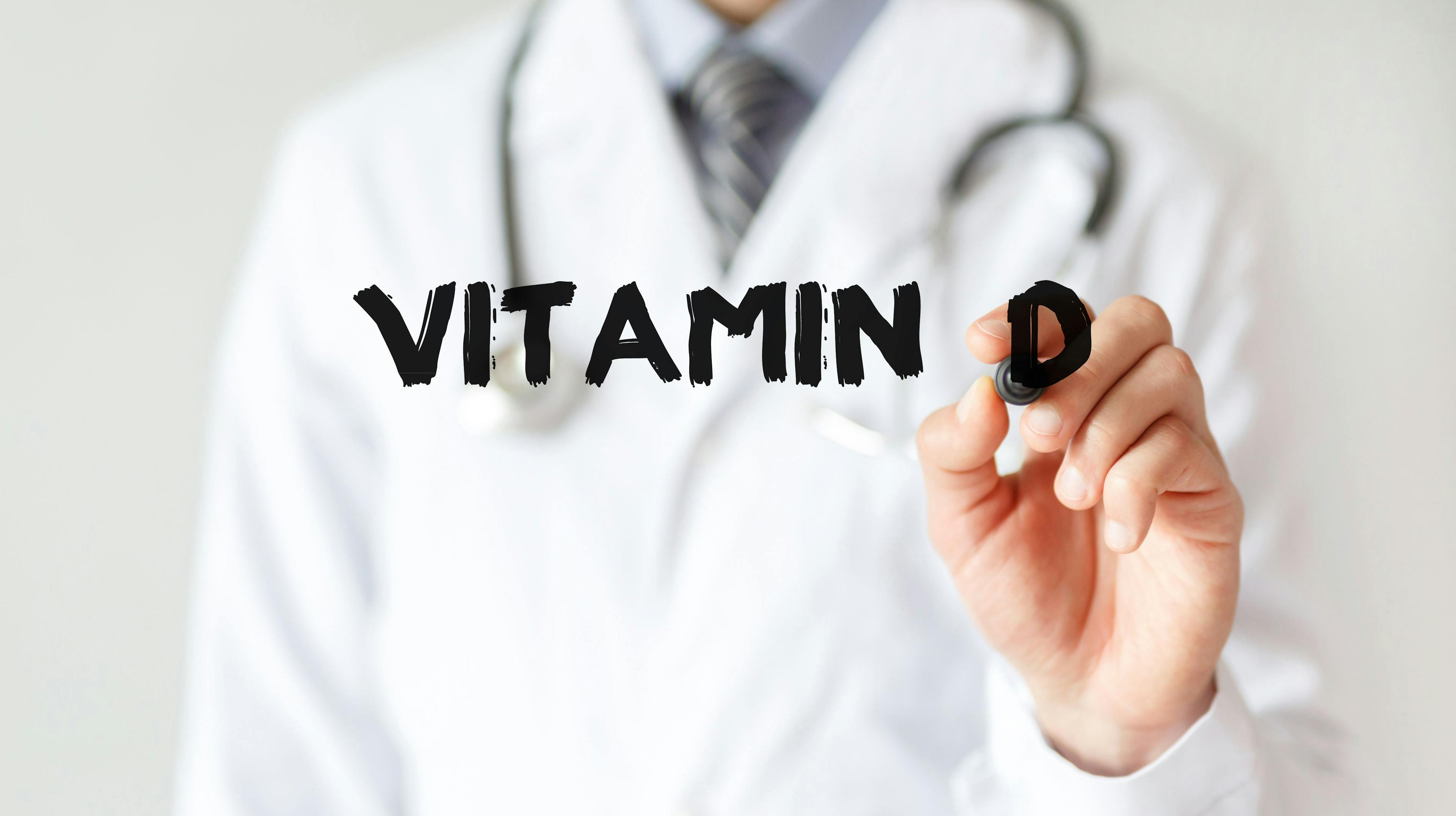 Doctor writing "vitamin D" with marker | Image Credit: MP Studio - stock.adobe.com