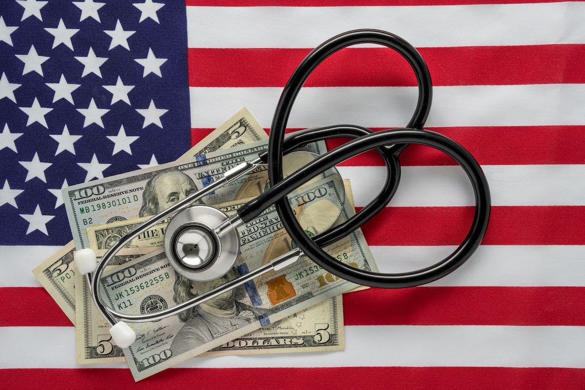 American flag, dollars, stethoscope - Rosemarie Mosteller - stock.adobe.com