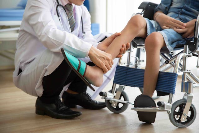 Doctor checking person's leg for muscle weakness | Image credit: Danai - stock.adobe.com