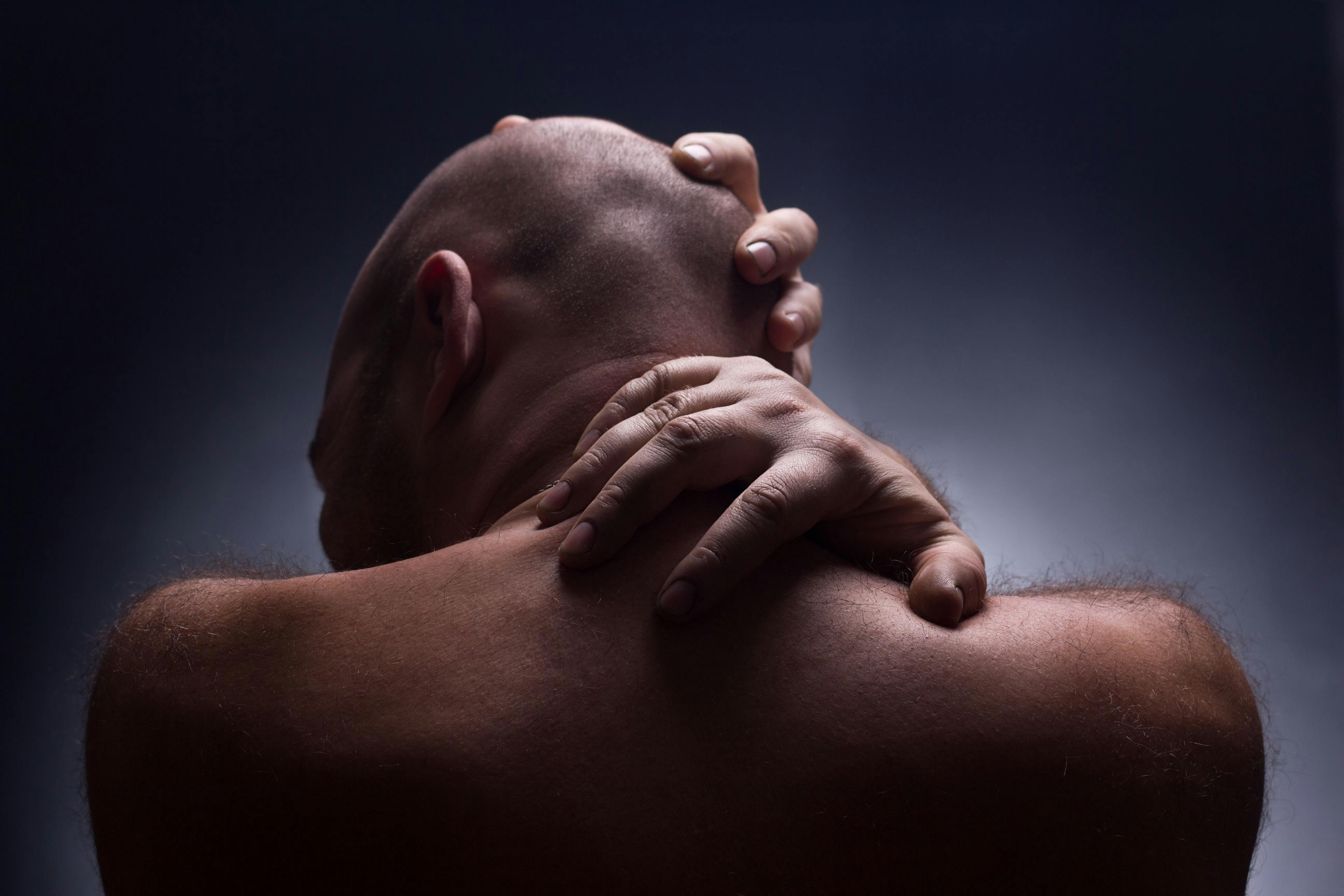 Back of head and neck in man with pain