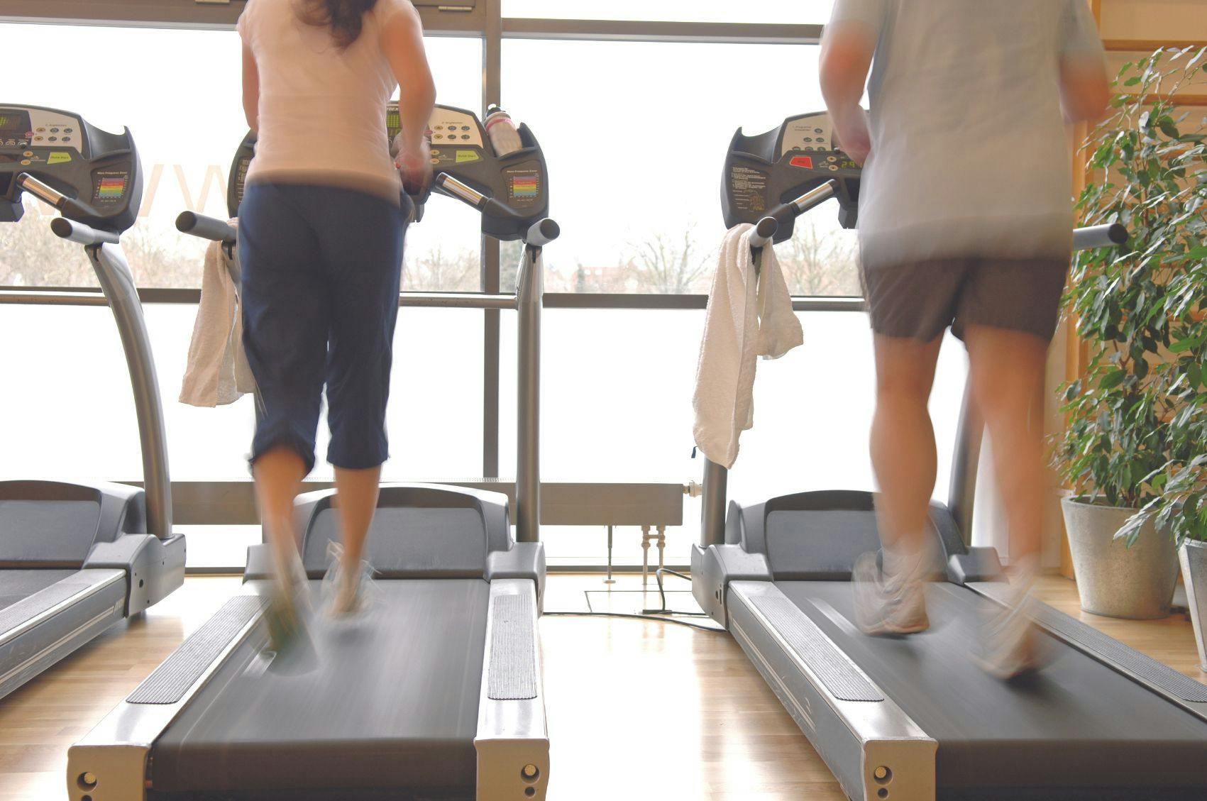 Couple walking on treadmills