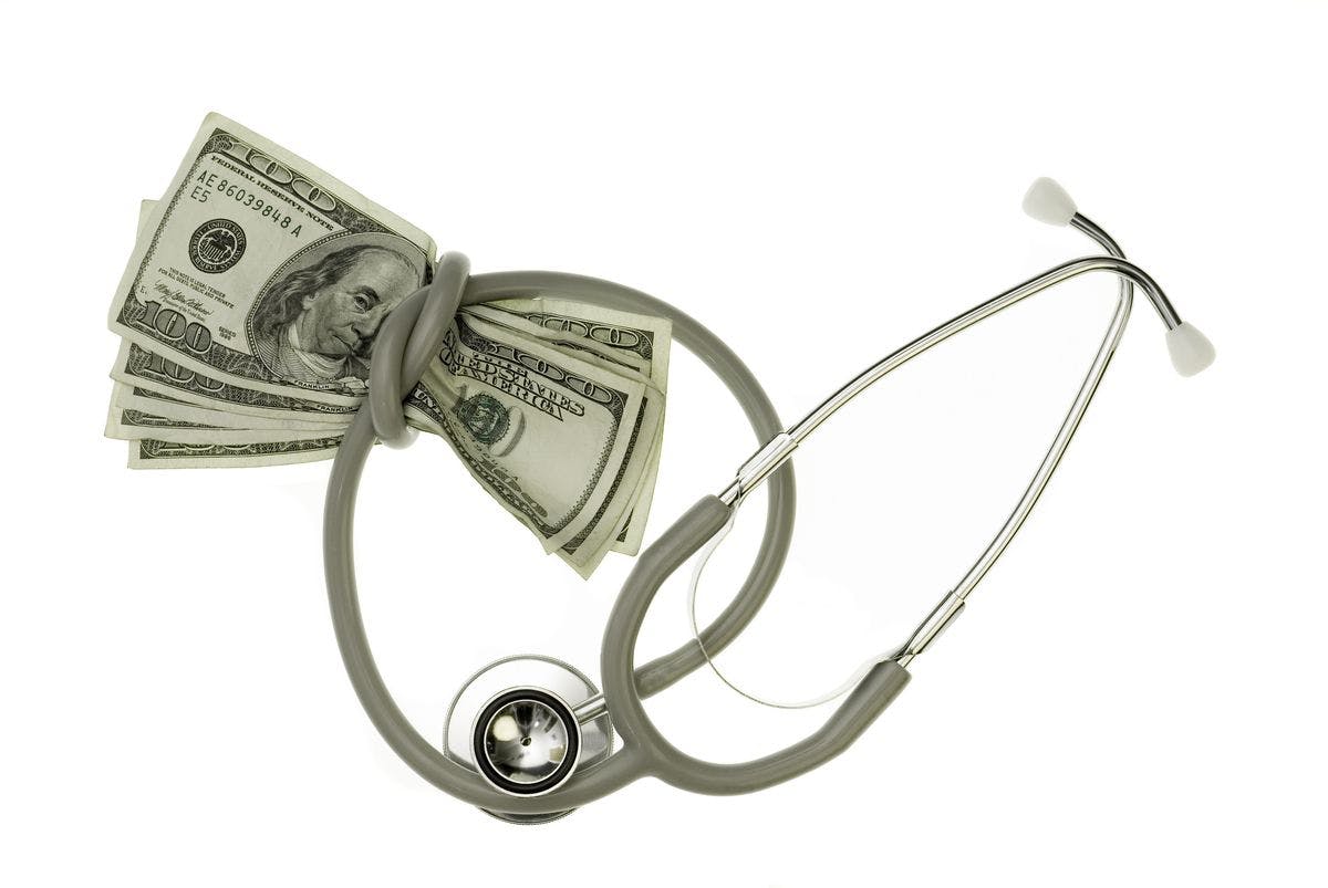 image of stethoscope wrapped around money