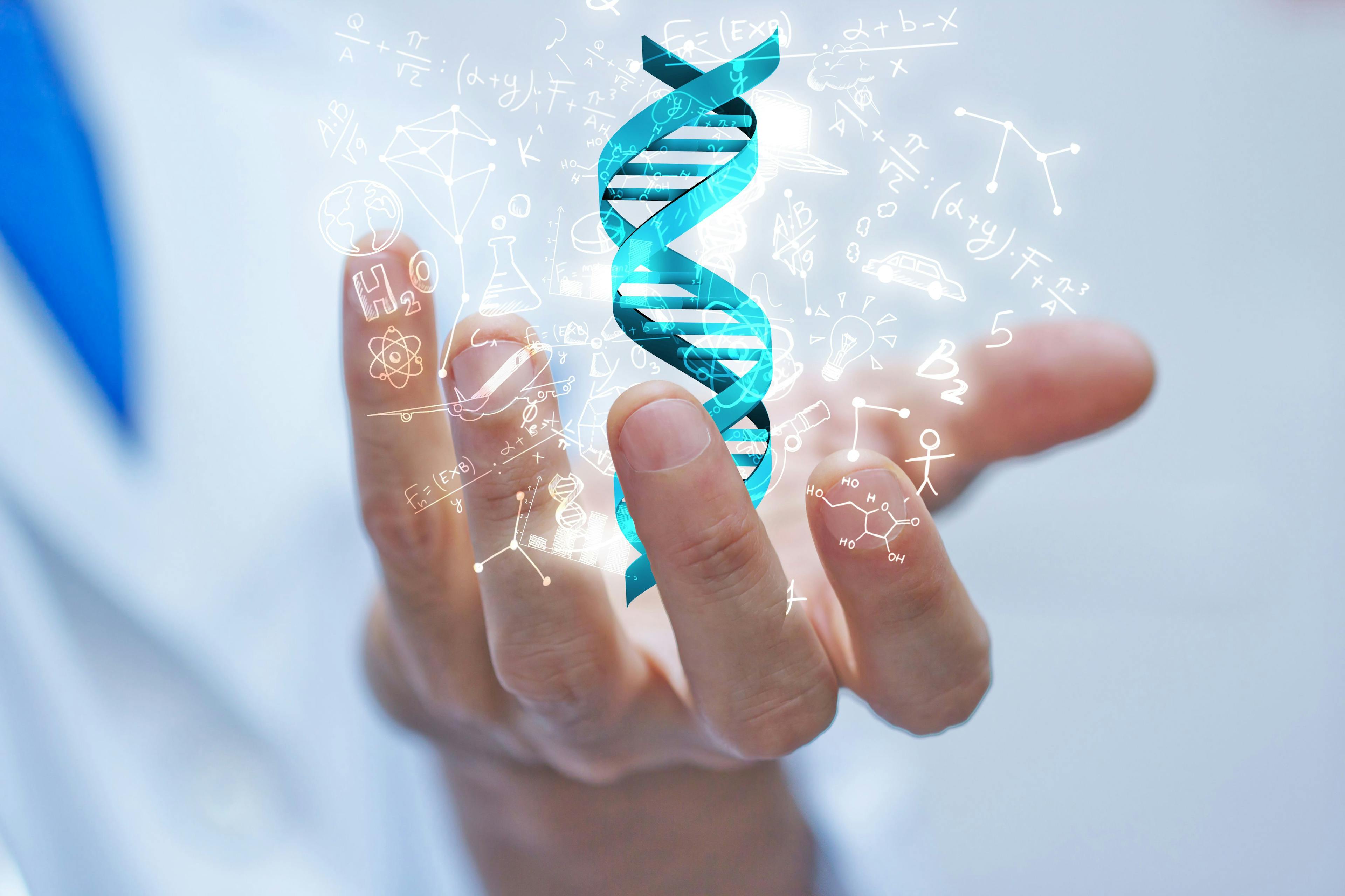 man holding a model of DNA with symbols surrounding it