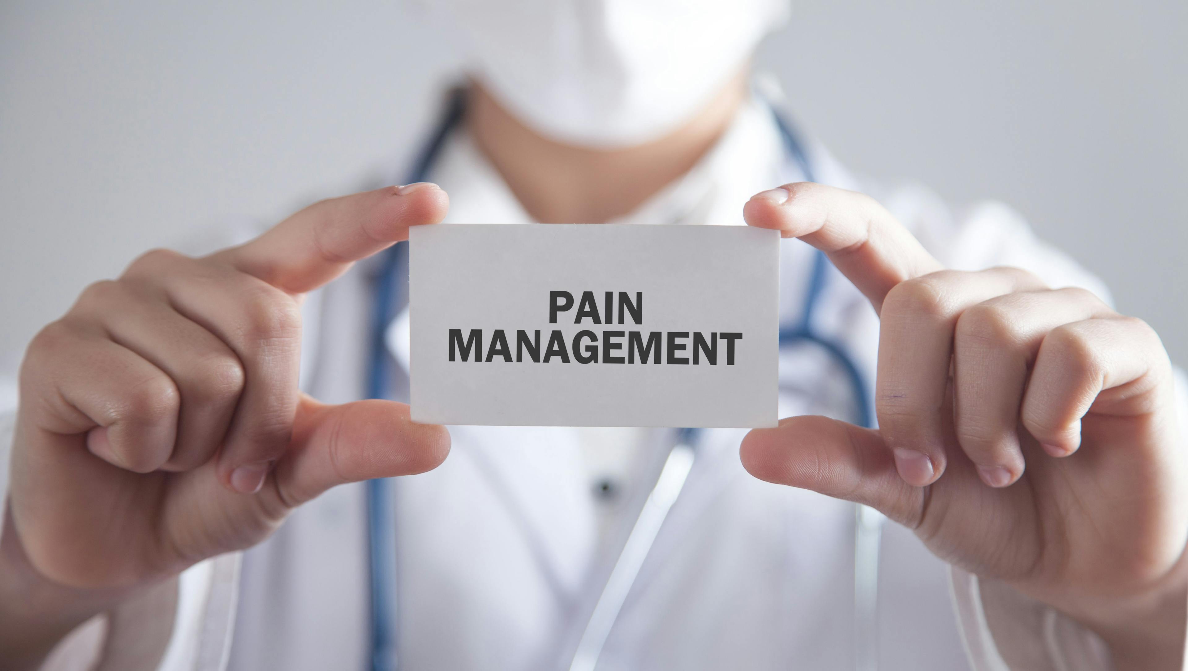 Doctor Displaying Pain Management Card | image credit: andranik123 - stock.adobe.com