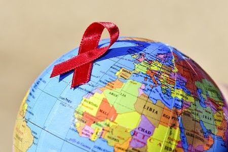 globe with red HIV ribbon on it