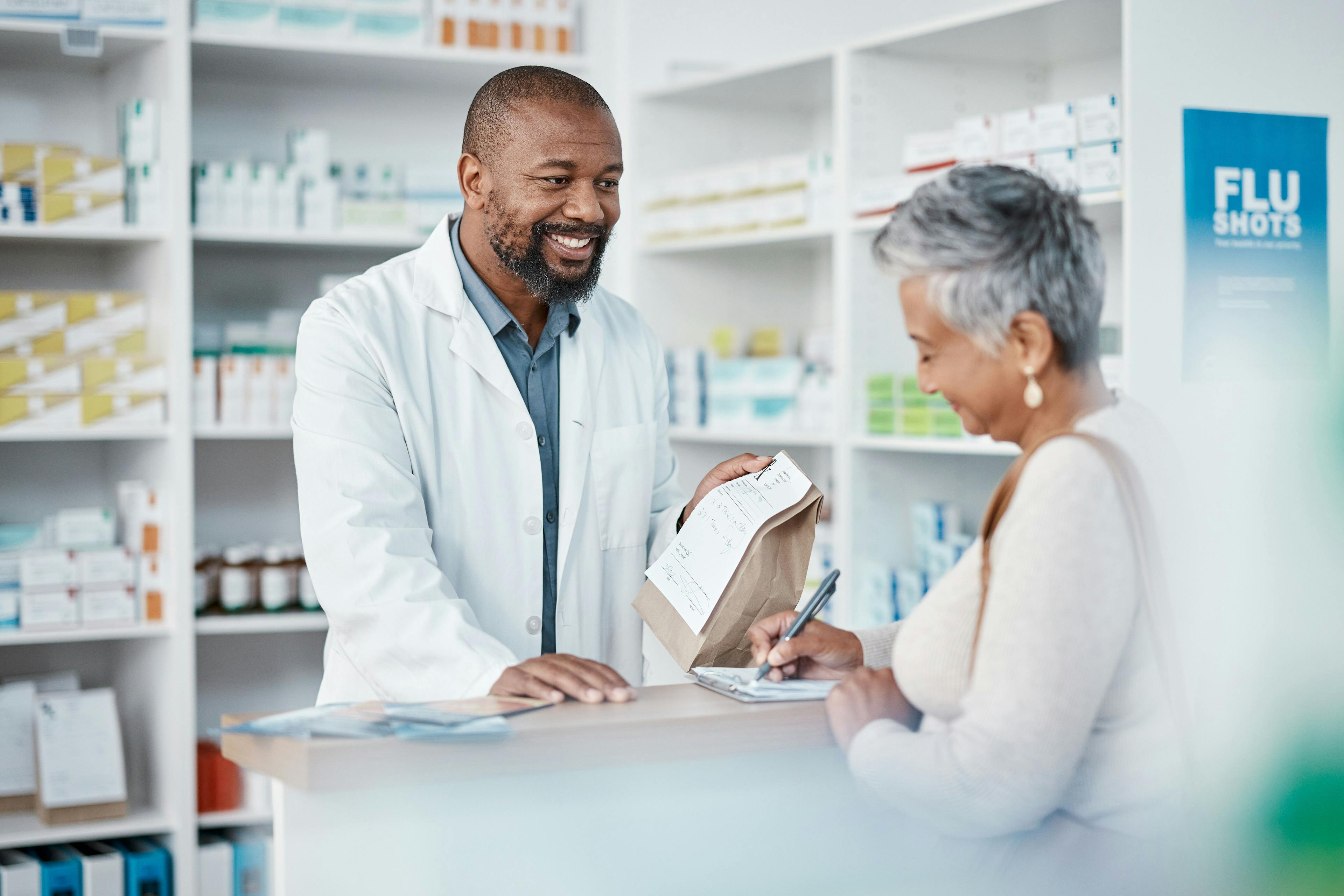 pharmacist giving patient a prescription | Image credit: Clayton D/peopleimages.com – stock.adobe.com