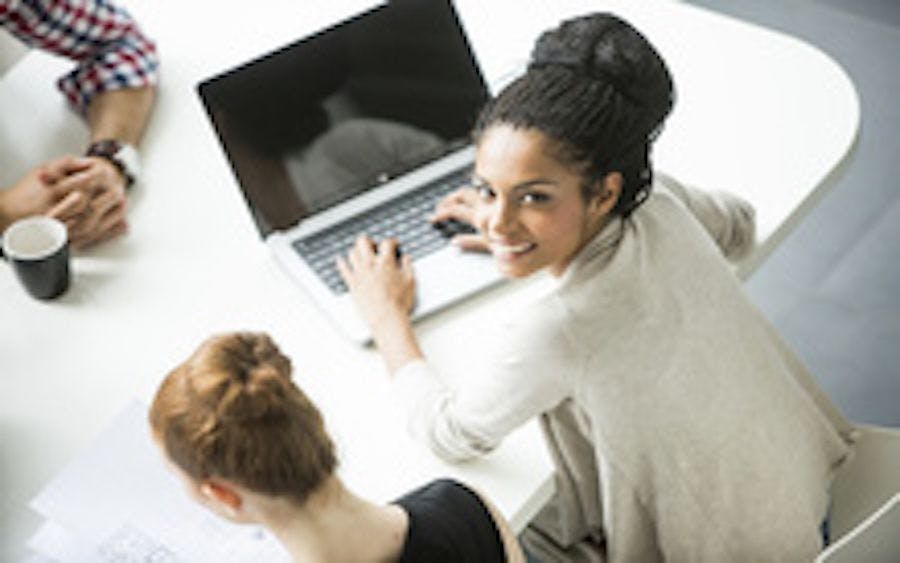 Image of a Black woman on a laptop