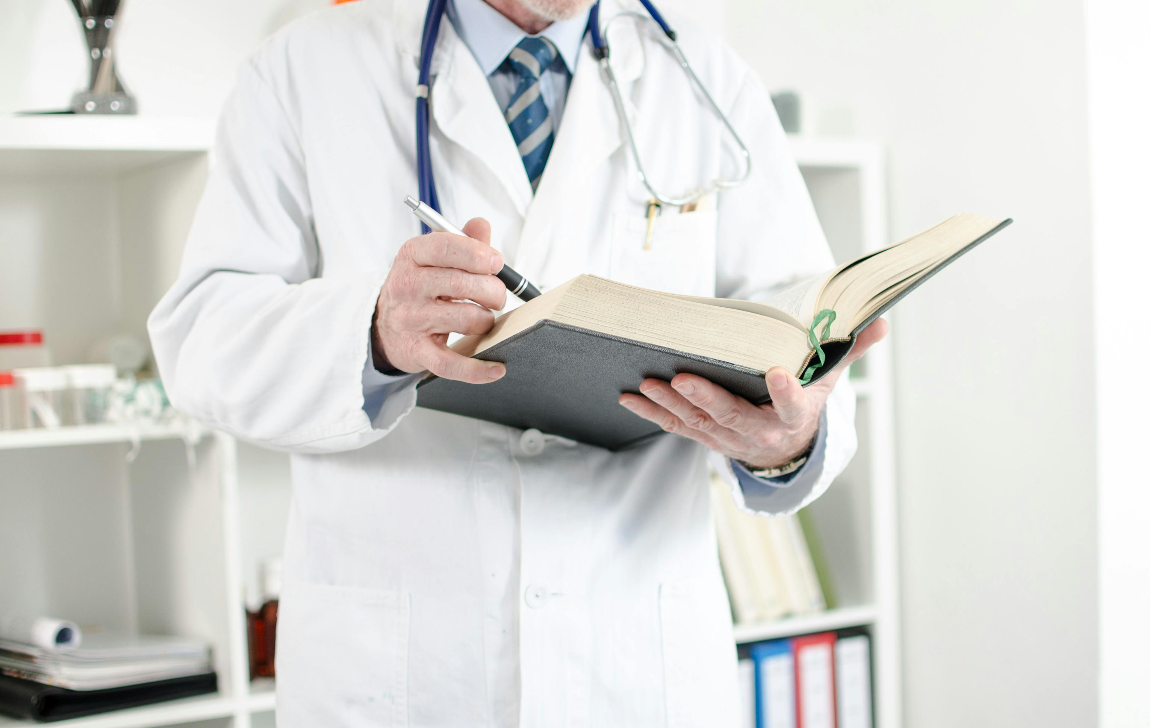 Doctor reading medical book