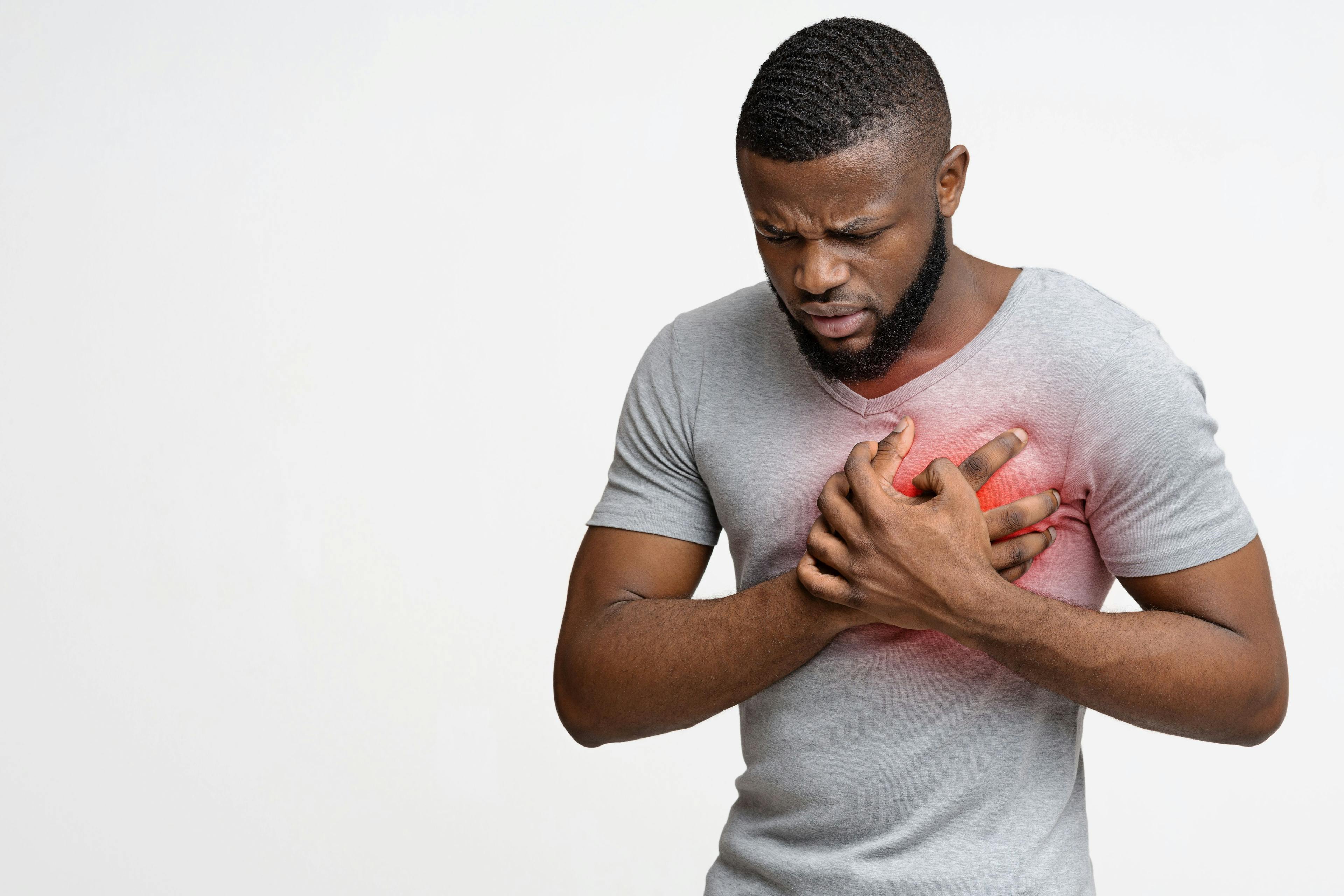 Young black guy having heart attack, holding his chest | Image credit: Prostock-studio - stock.adobe.com