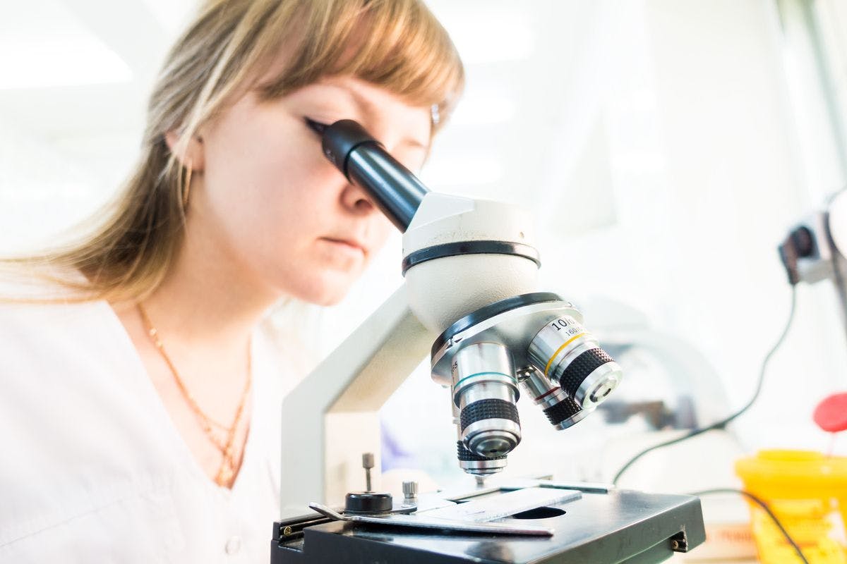 Image of lab worker at microscope
