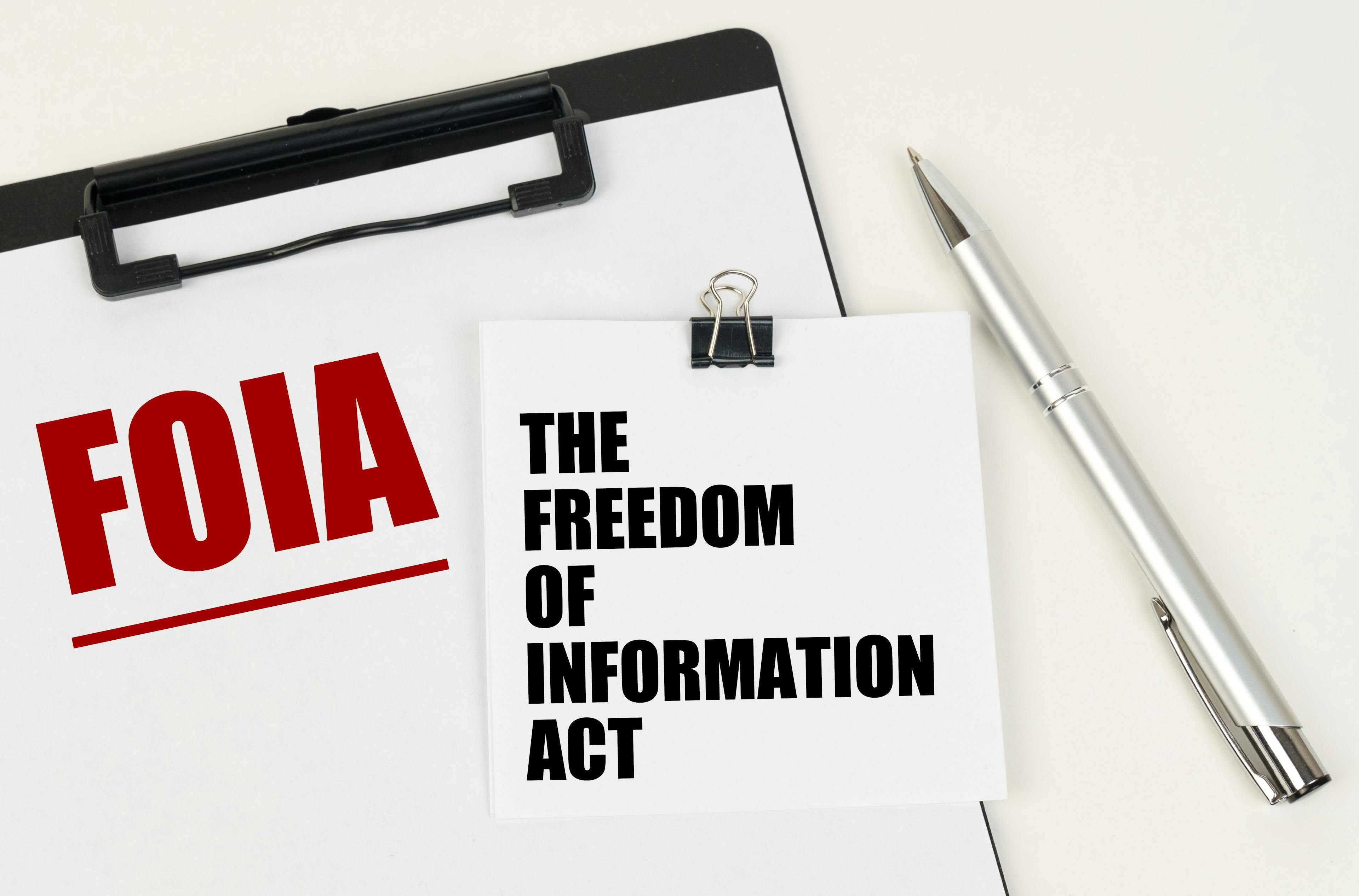 On the tablet, a sheet of paper and stickers with the inscription - FOIA, THE FREEDOM OF INFORMATION ACT | Image Credit: Dzmitry - stock.adobe.com