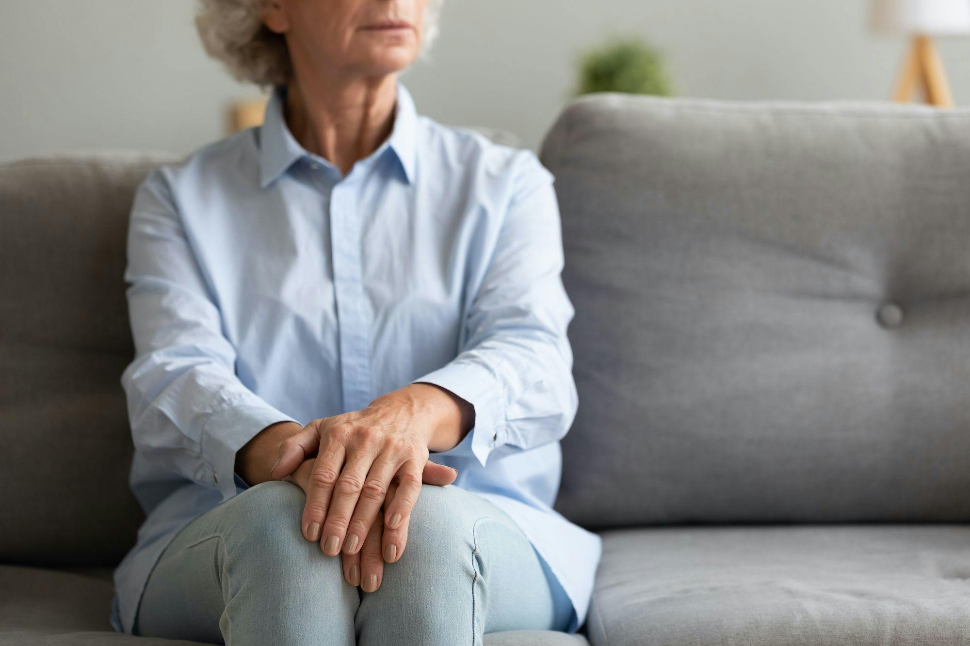 elderly woman sitting on couch