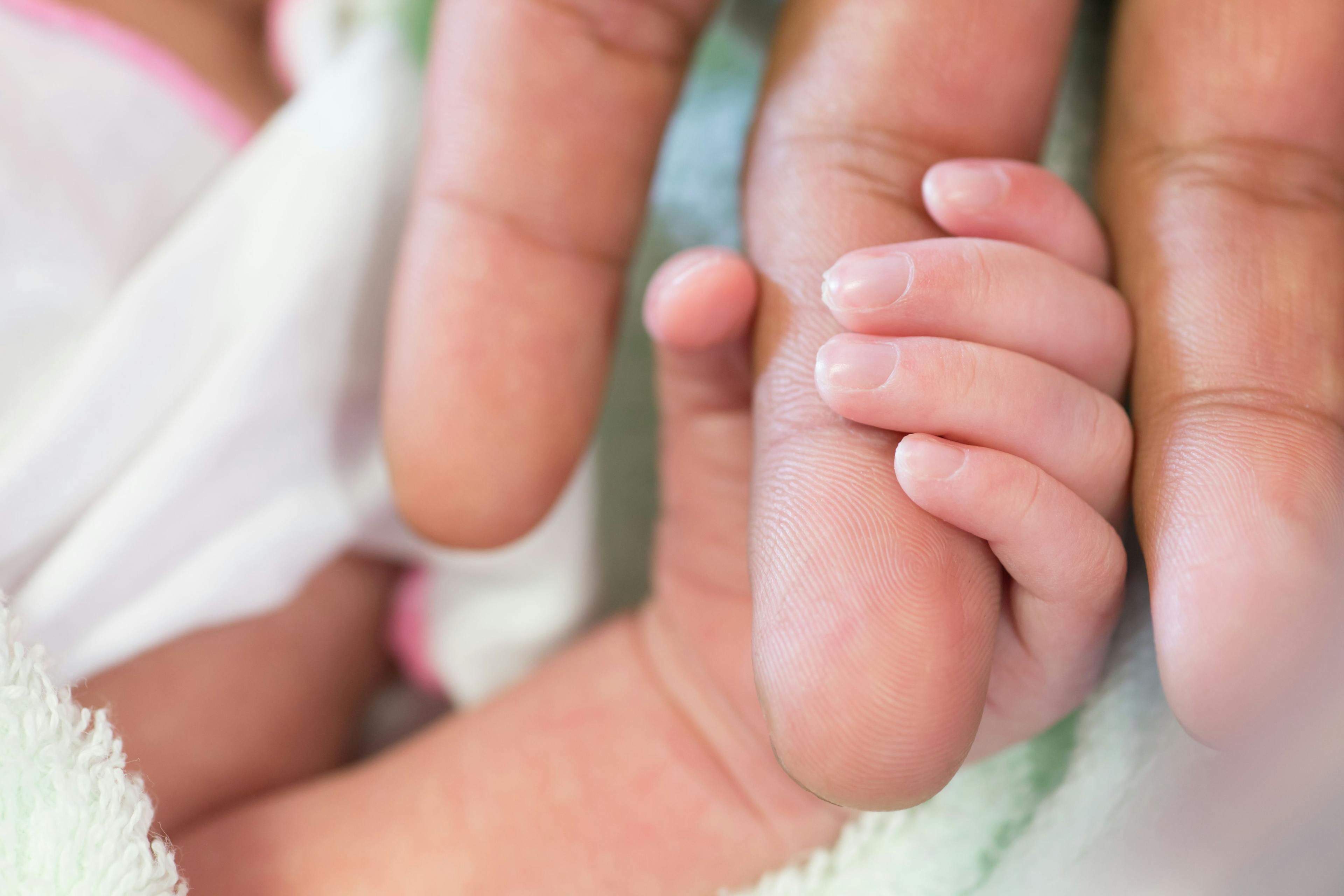 closeup of newborn grabbing mother's finger | Image Credit: rufous - stock.adobe.com