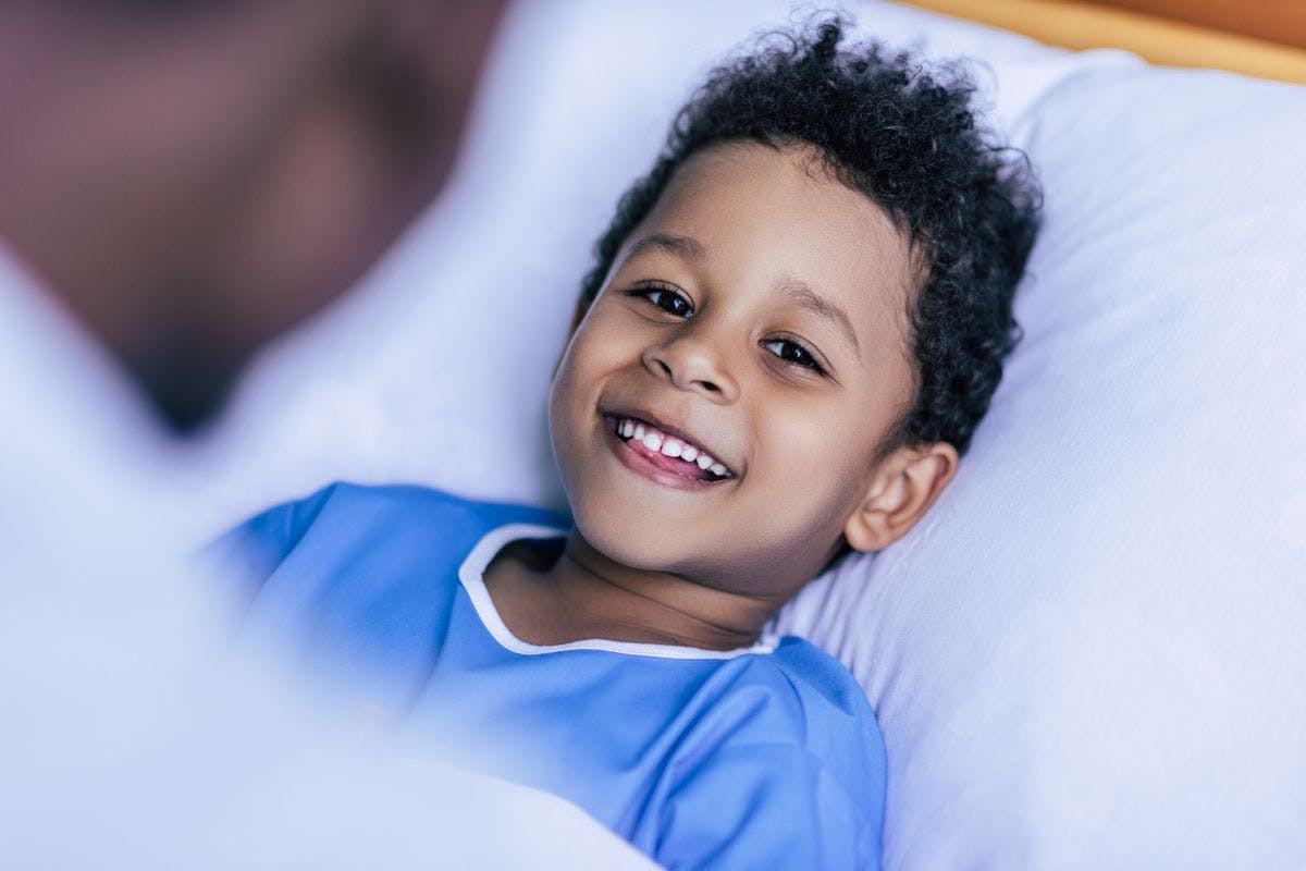 Happy child in hospital bed