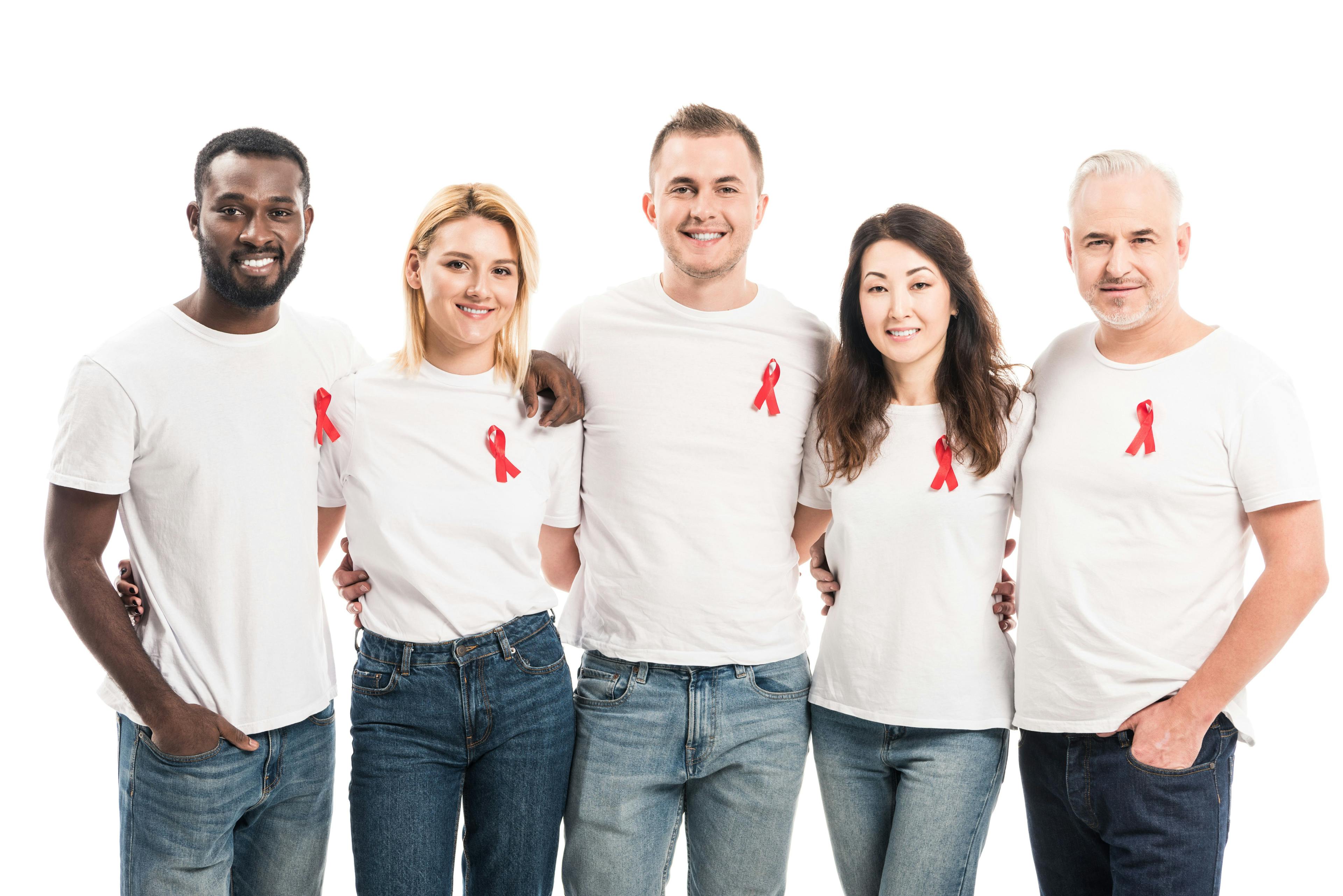 group of 5 people standing, wearing white shirts and red HIV ribbons