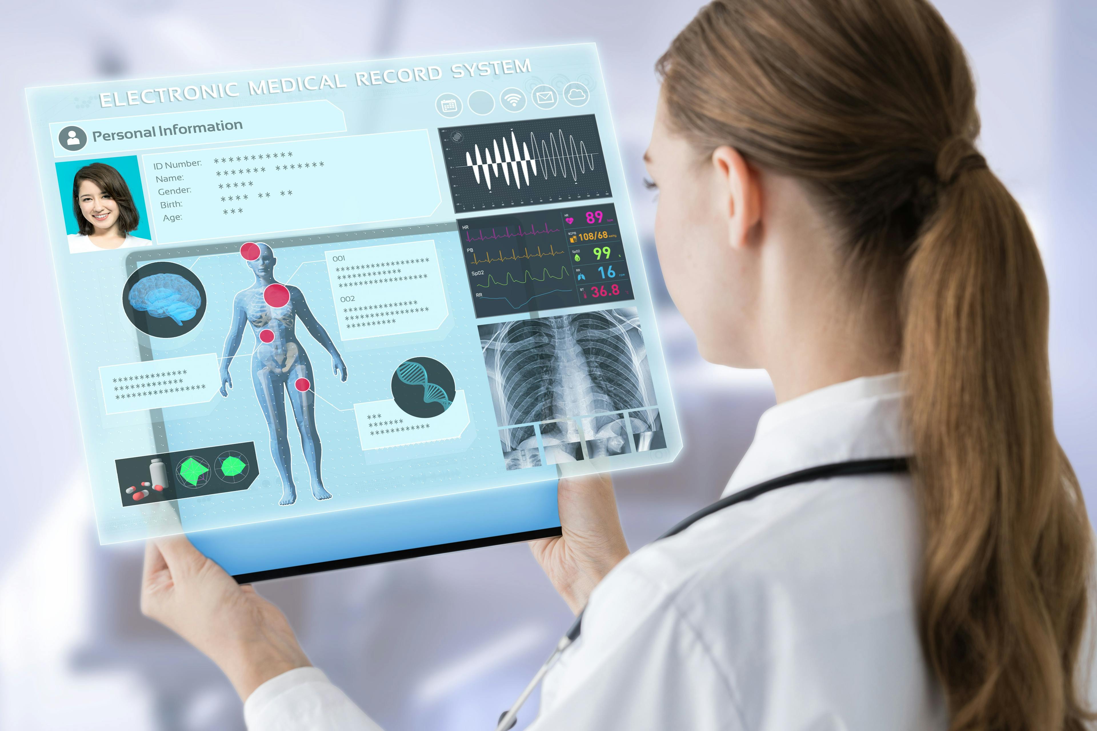 doctor looking at a digital screen containing illegible health information