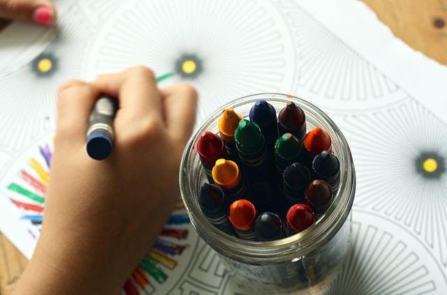 picture of child's hand with crayons