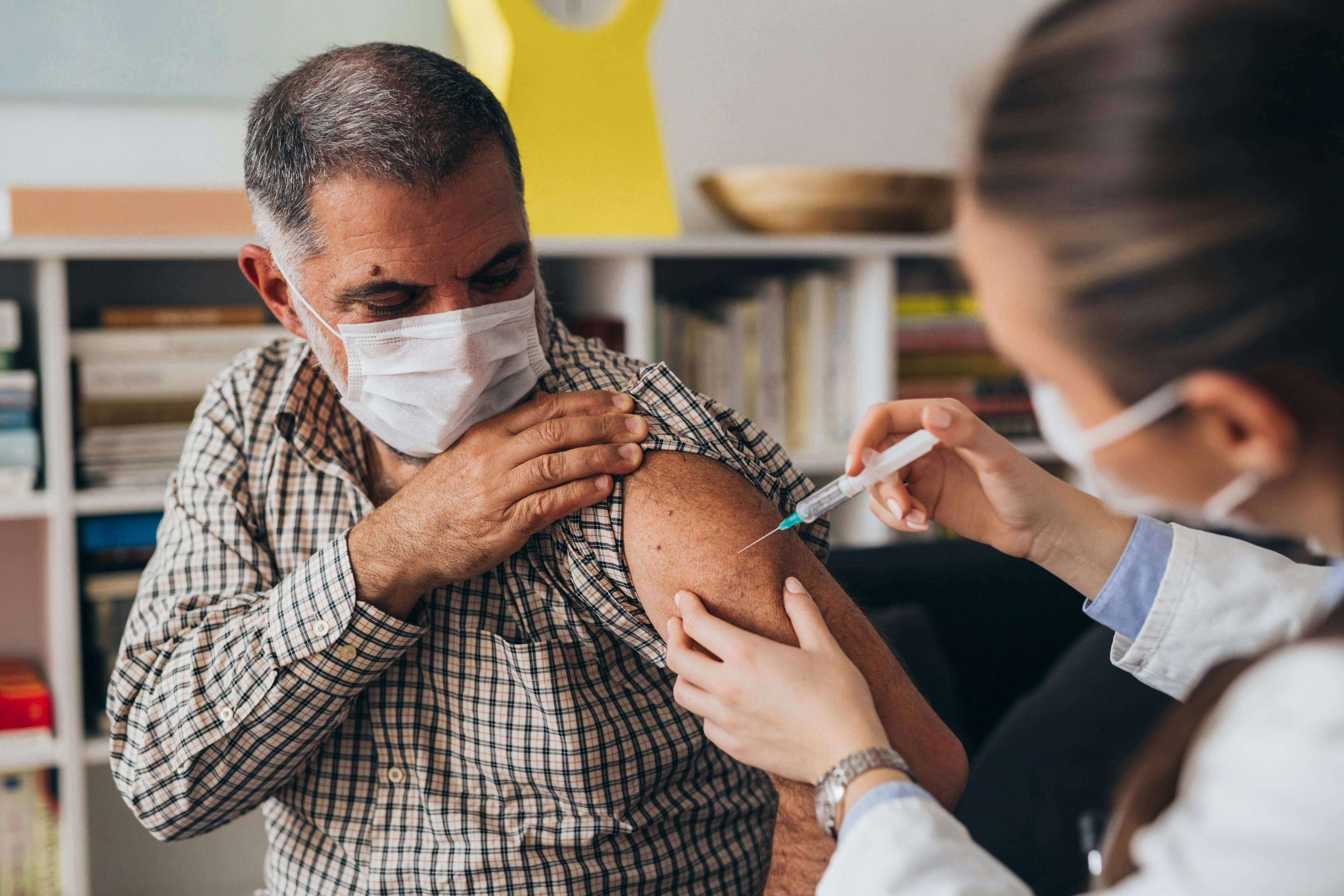 A doctor is administering a vaccine to a patient | cherryandbees - stock.adobe.com