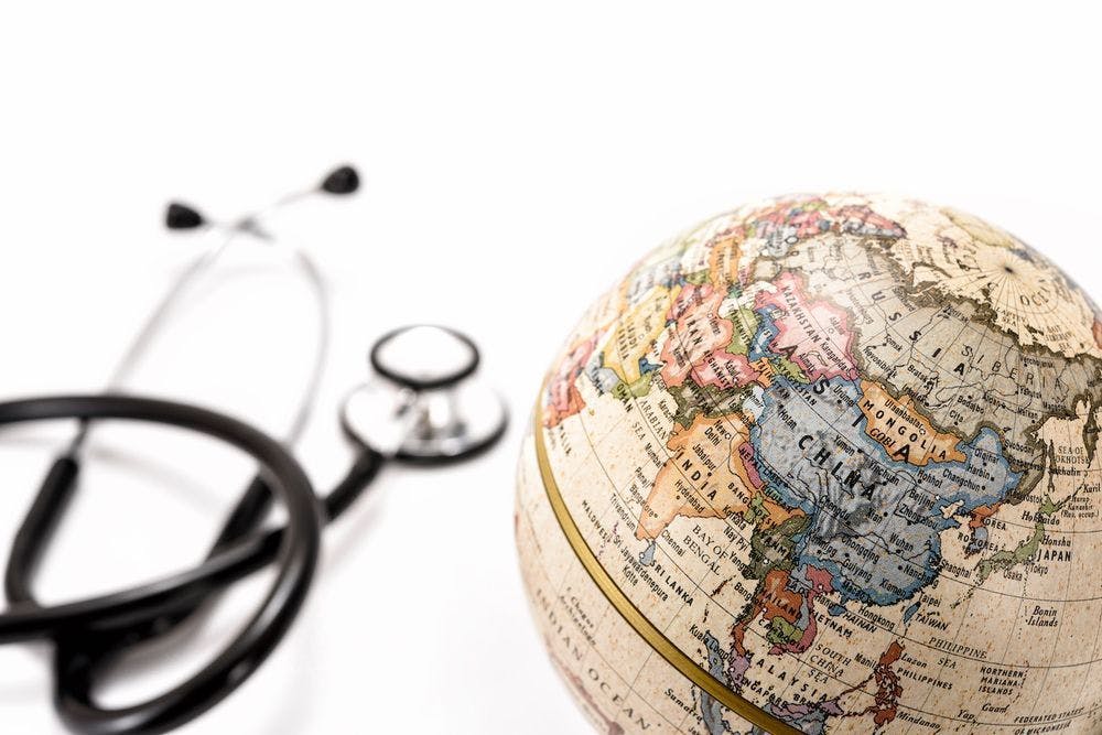 Image of a stethoscope next to a globe