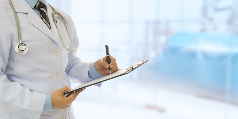 a doctor writing notes on a clipboard