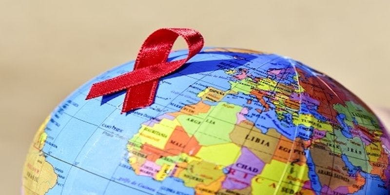 Hiv awareness ribbon on a globe. 