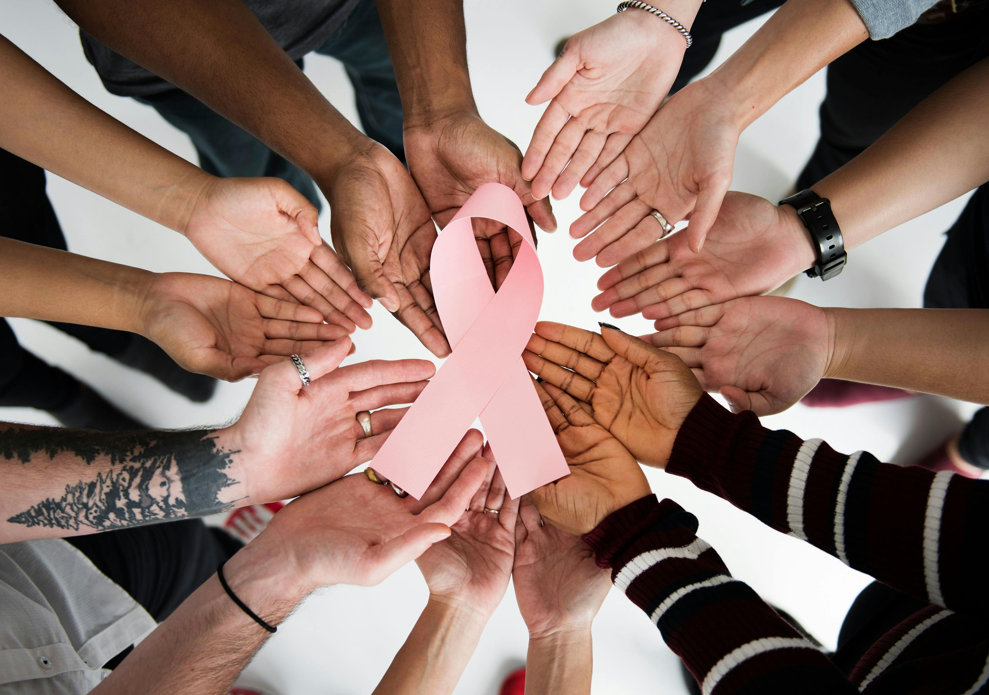 group of patinets holding a brast cancer awareness ribbon | Image credit: Rawpixel.com - stock.adobe.com