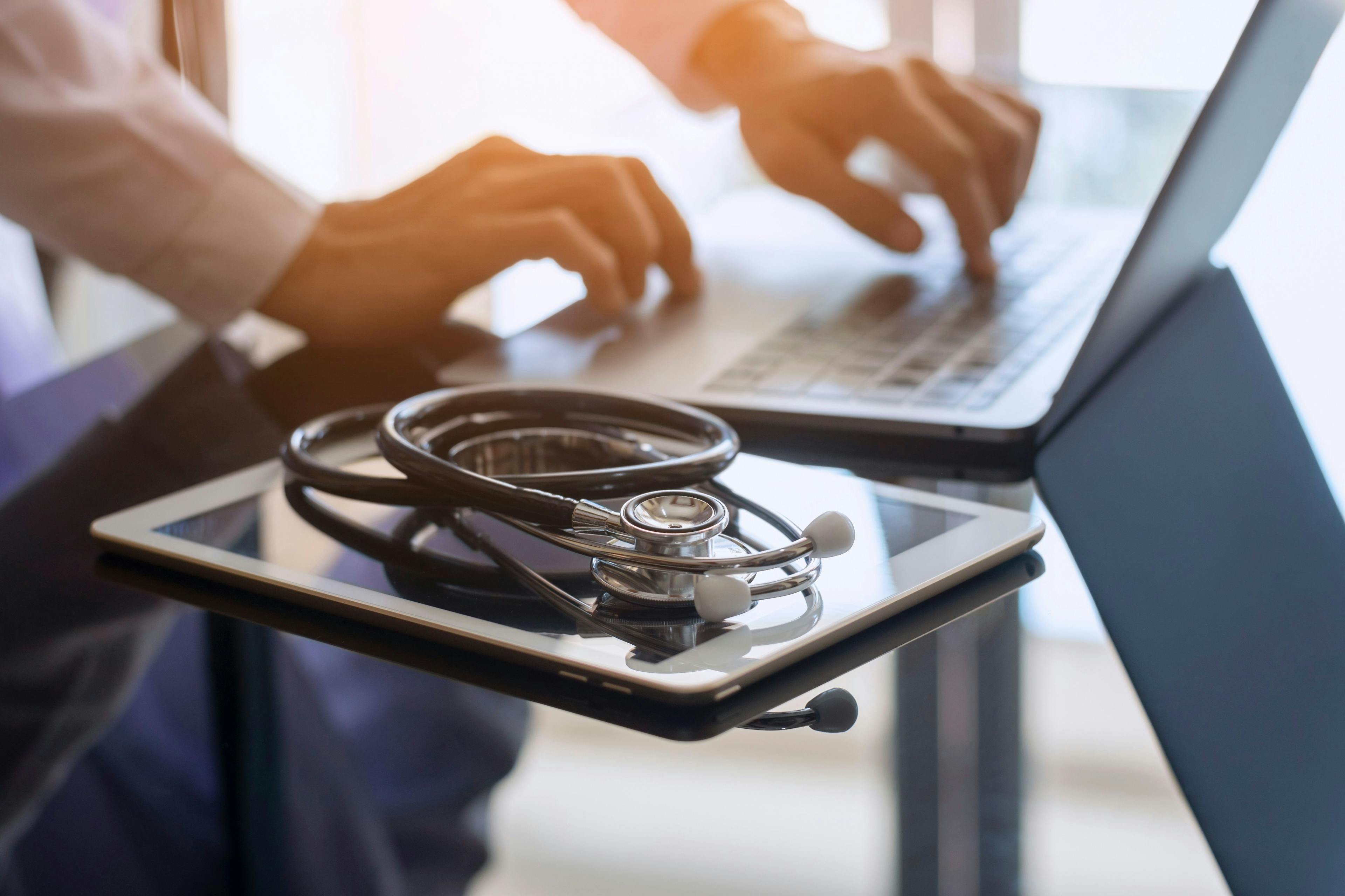 Telehealth with laptop, tablet, and stethoscope | Image credit: NIKCOA - stock.adobe.com