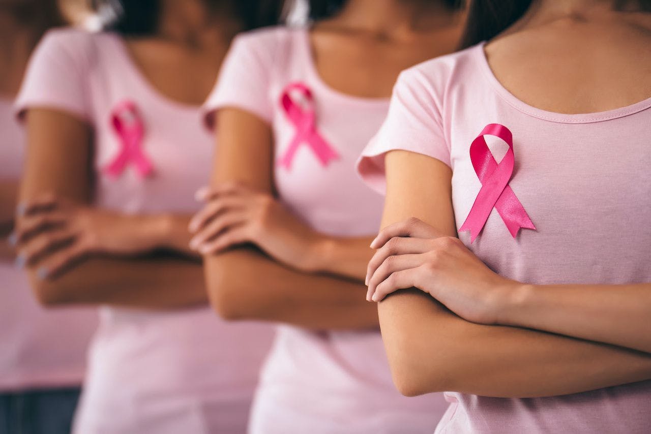women wearing pink shirt and pink ribbons