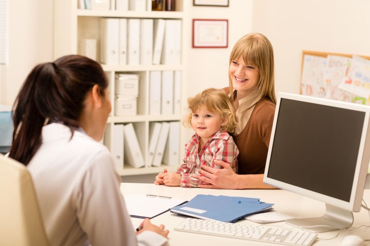 Child and parent speaking with physician.