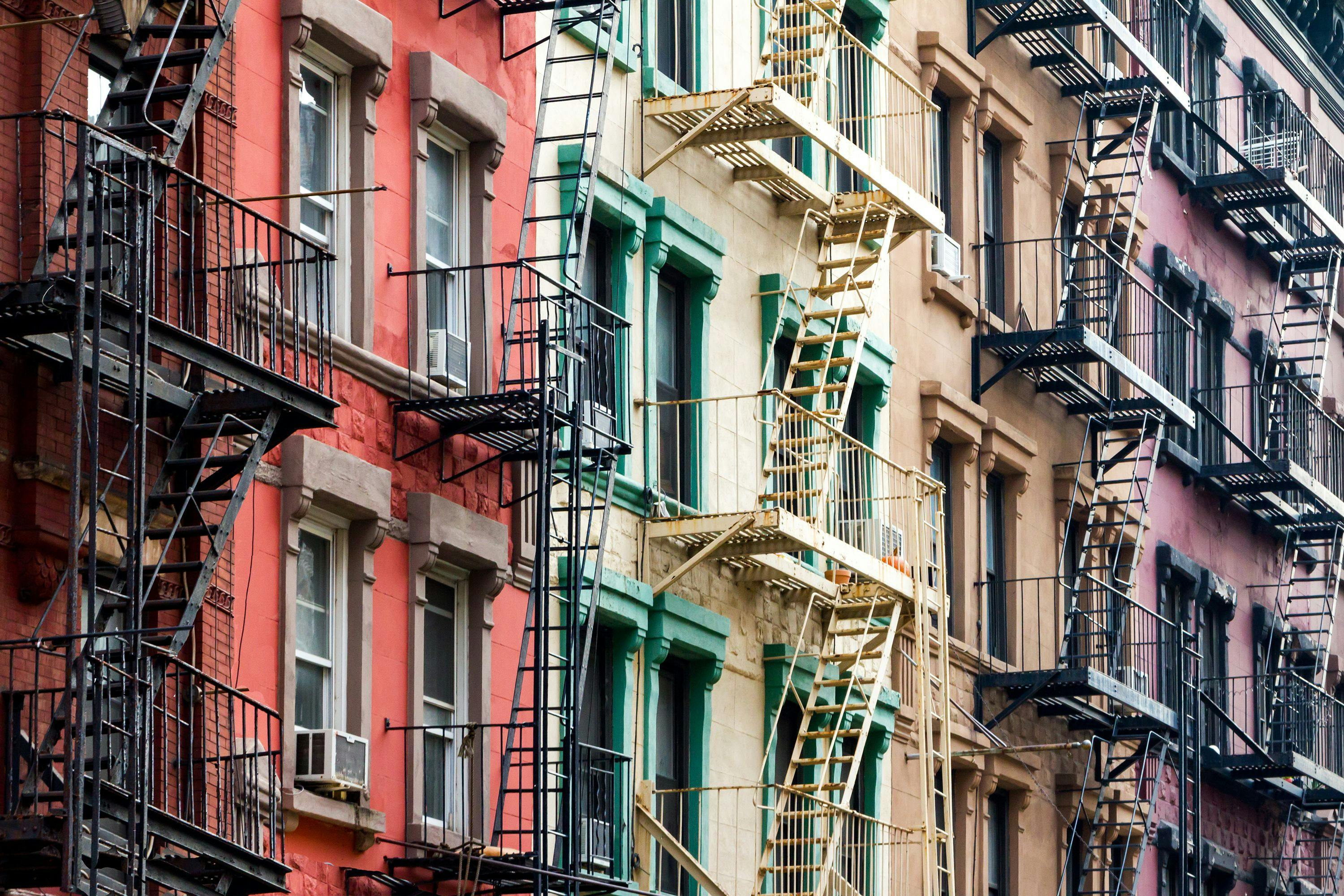 apartments of different colors with fire escapes