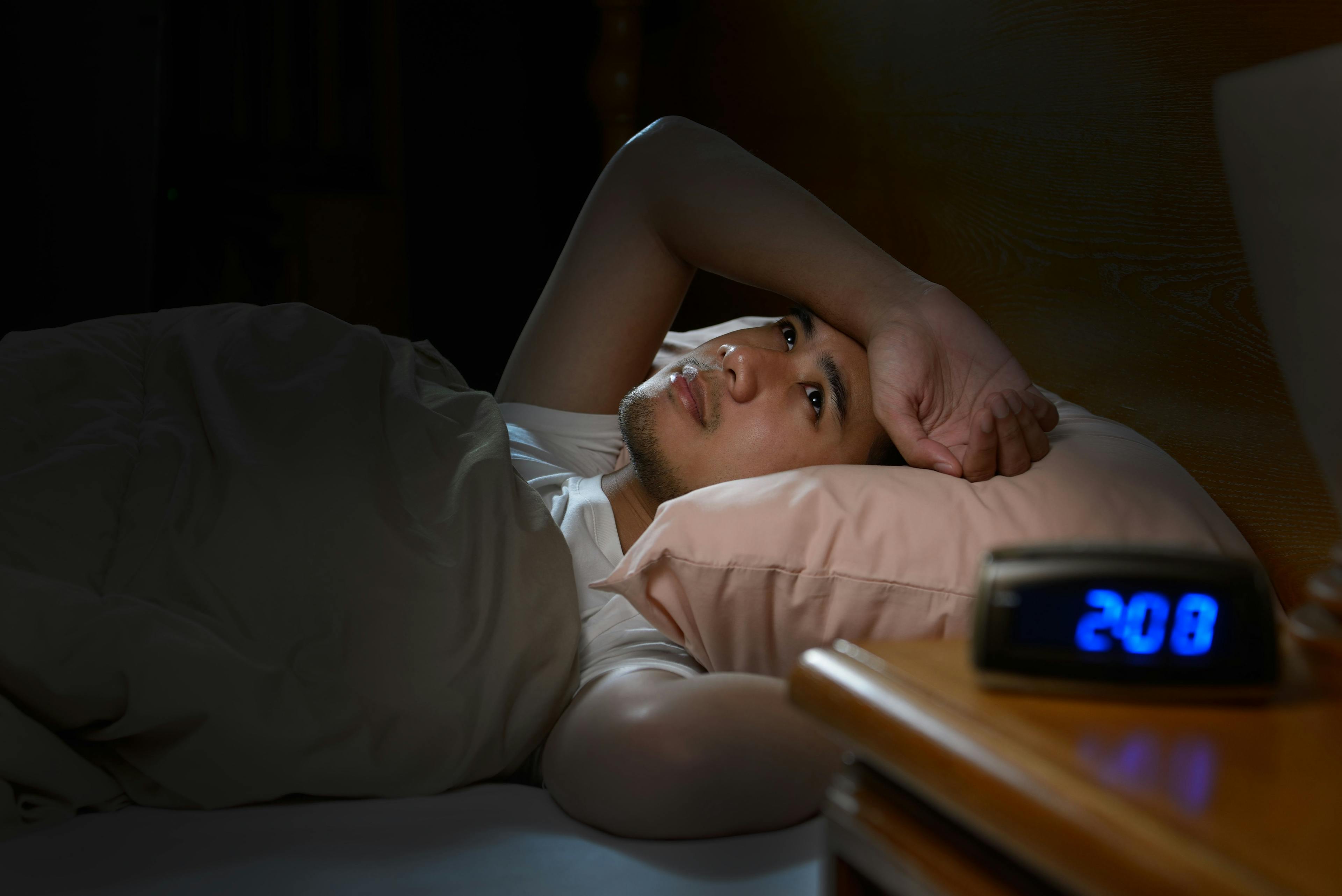 Depressed man suffering from insomnia lying in bed | Image Credit: amenic181 - stock.adobe.com