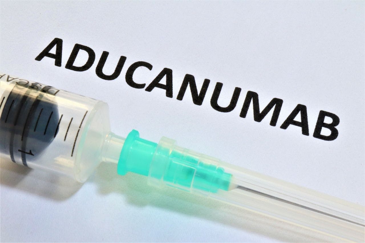 Needle under word aducanumab | Image credit: SpeedShutter - stock.adobe.com