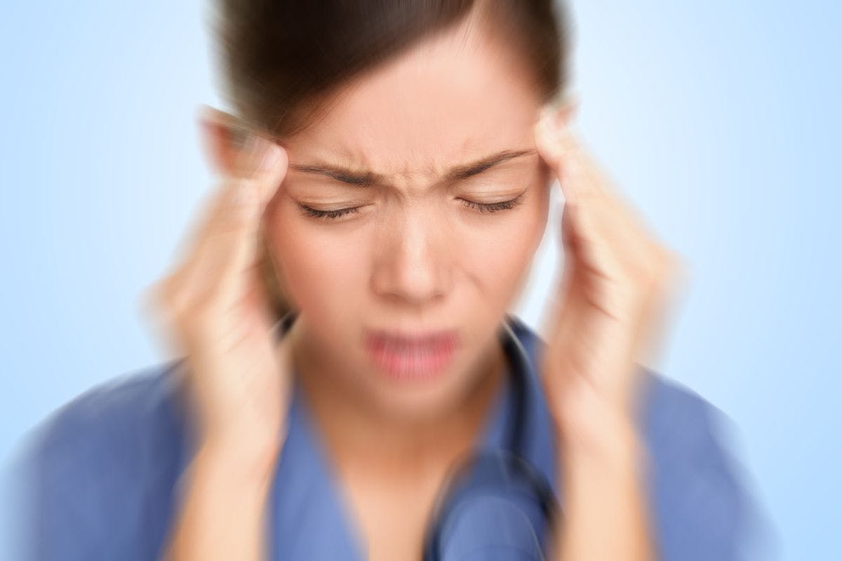 Health care worker experiencing migraine
