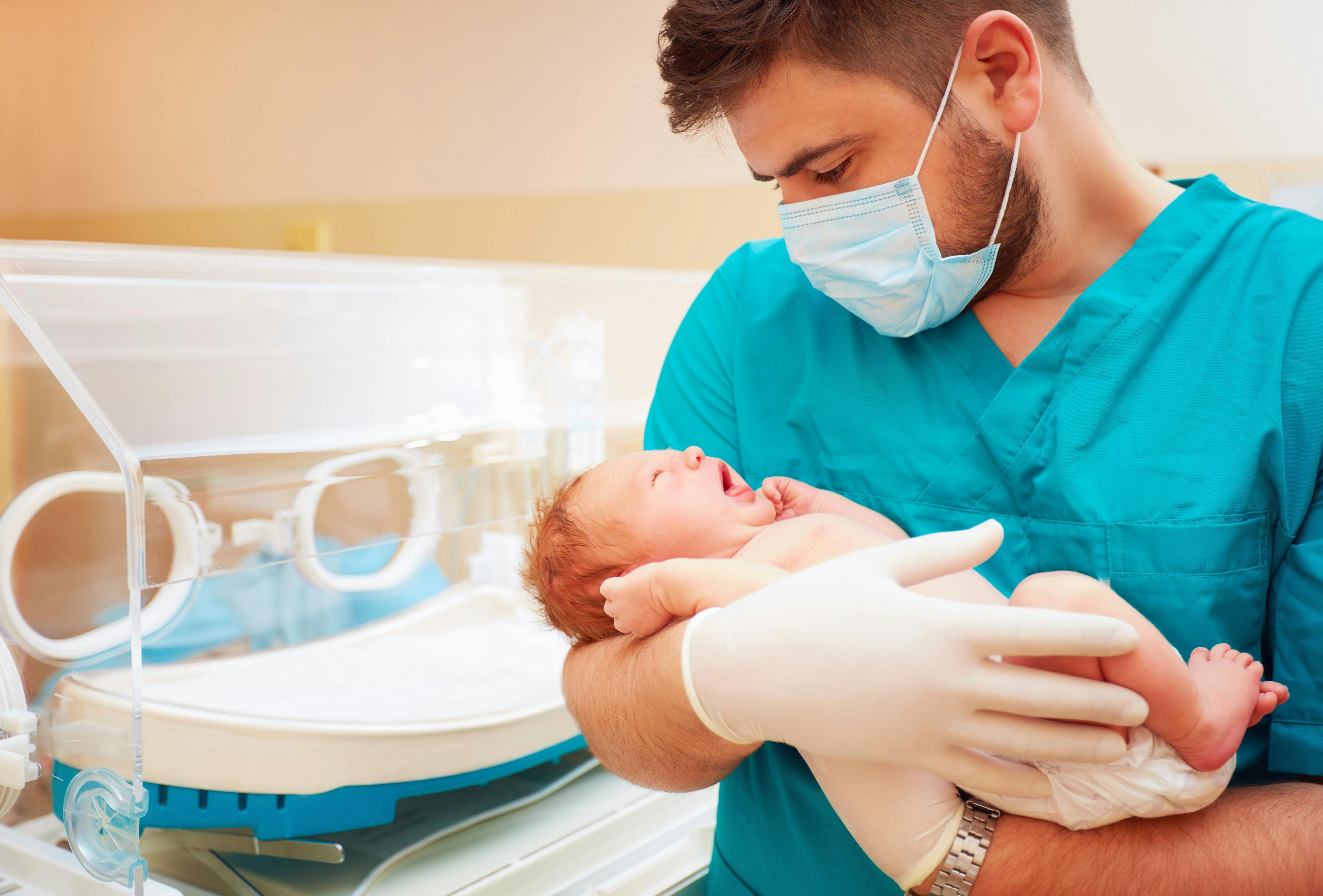 Doctor with premature infant