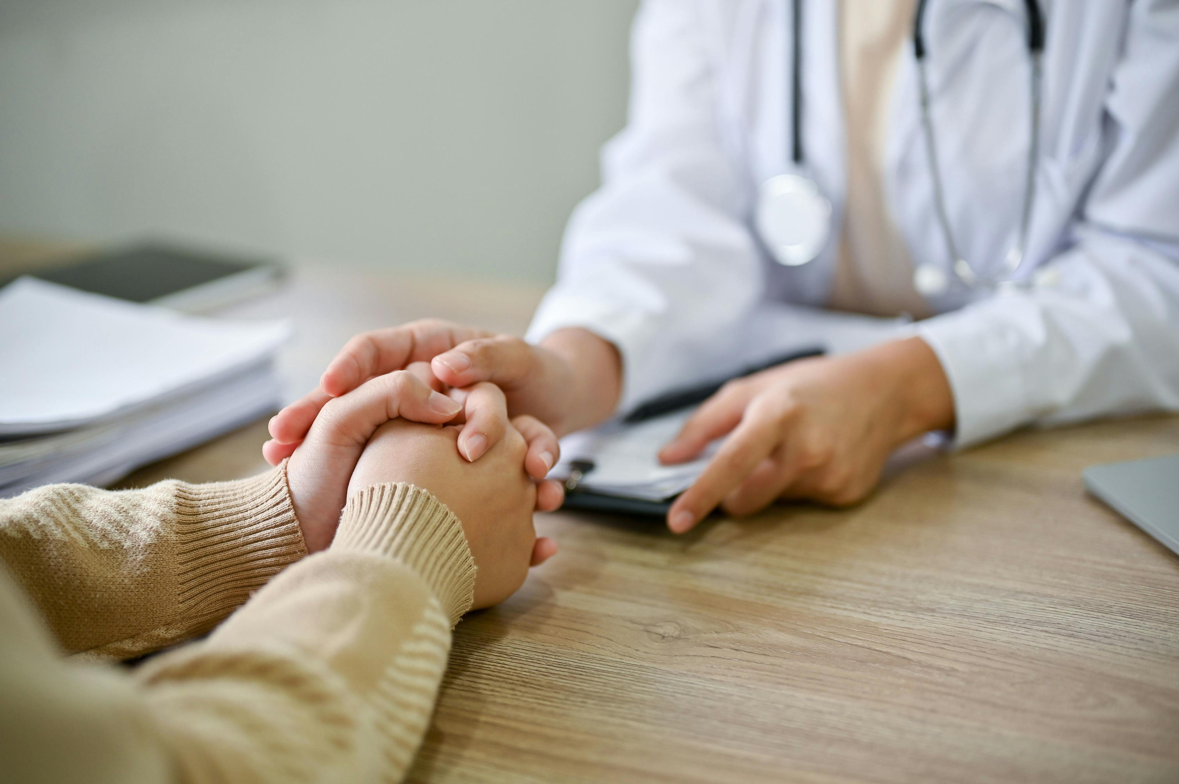 Close up view of doctor touching patient hand, showing empathy and kindness | Image credit: bongkarn - stock.adobe.com