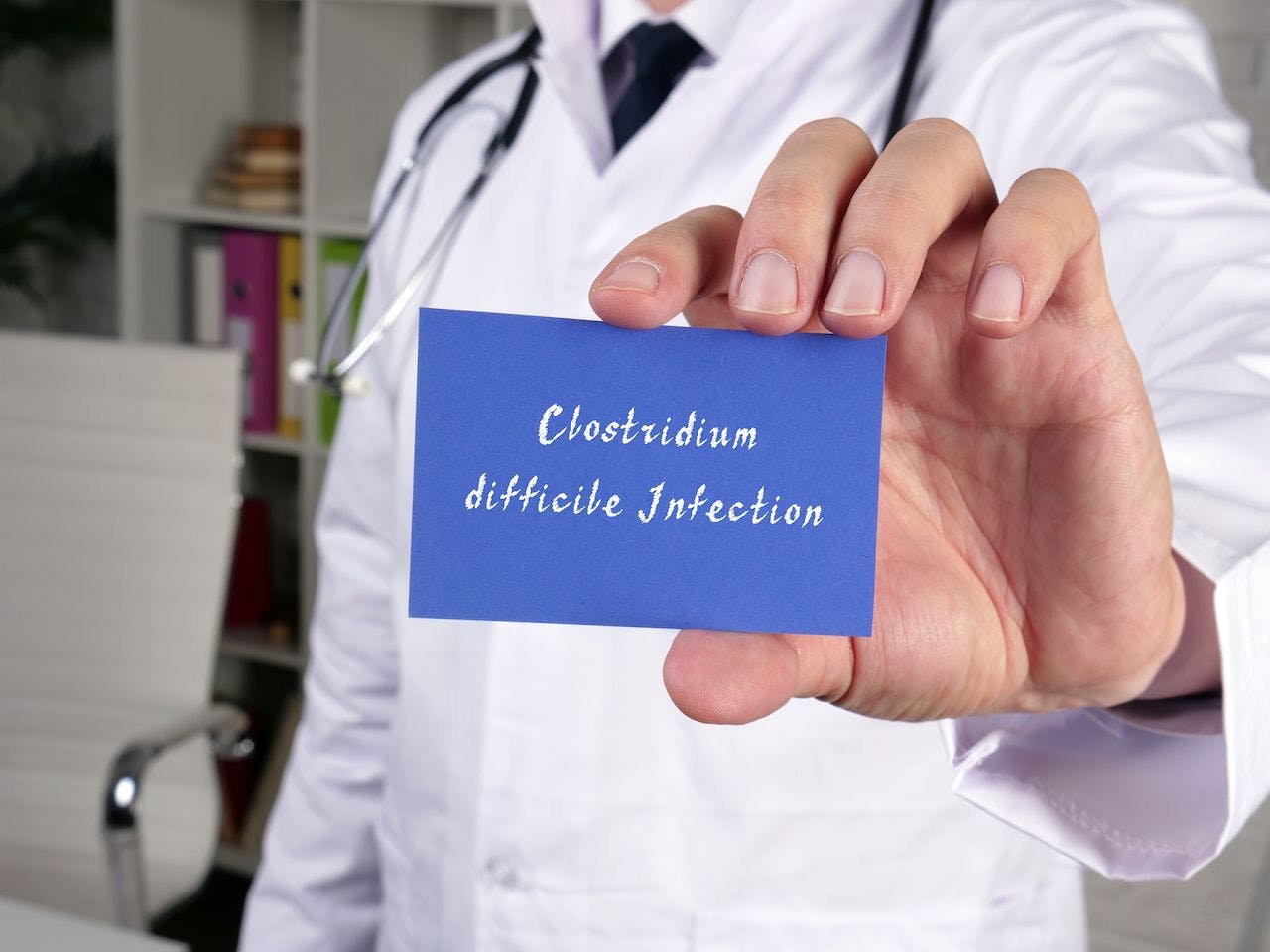 Health care concept meaning Clostridium difficile Infection with phrase on the piece of paper: © Yurii Kibalnik - stock.adobe.com